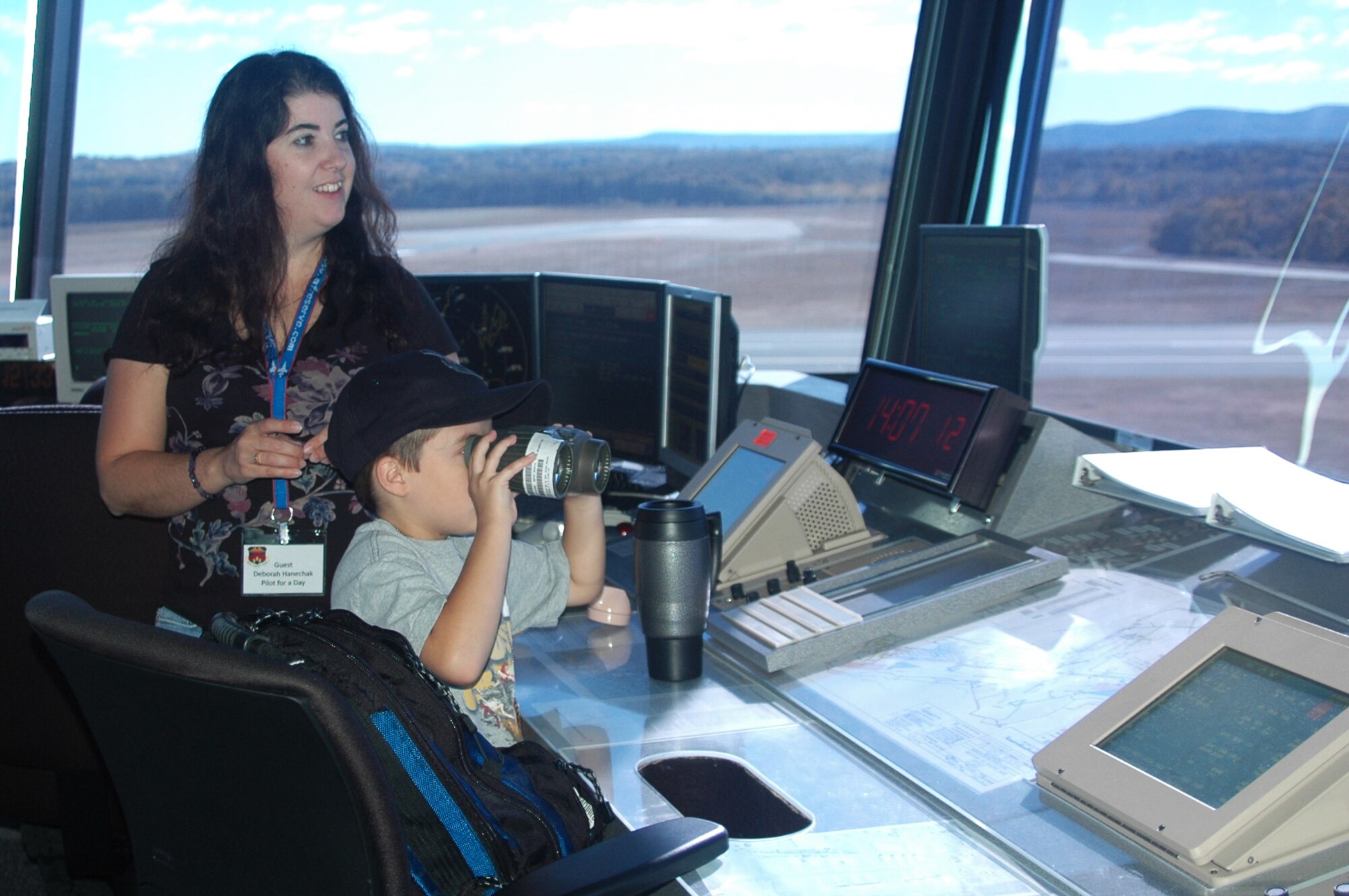 Brandon Hanechak and his mom, Deborah, look out onto the flight line from inside the Westover air traffic control tower.  Brandon came to Westover as the first Pilot for Day and was named an honorary 337th Airlift Squadron C-5 pilot