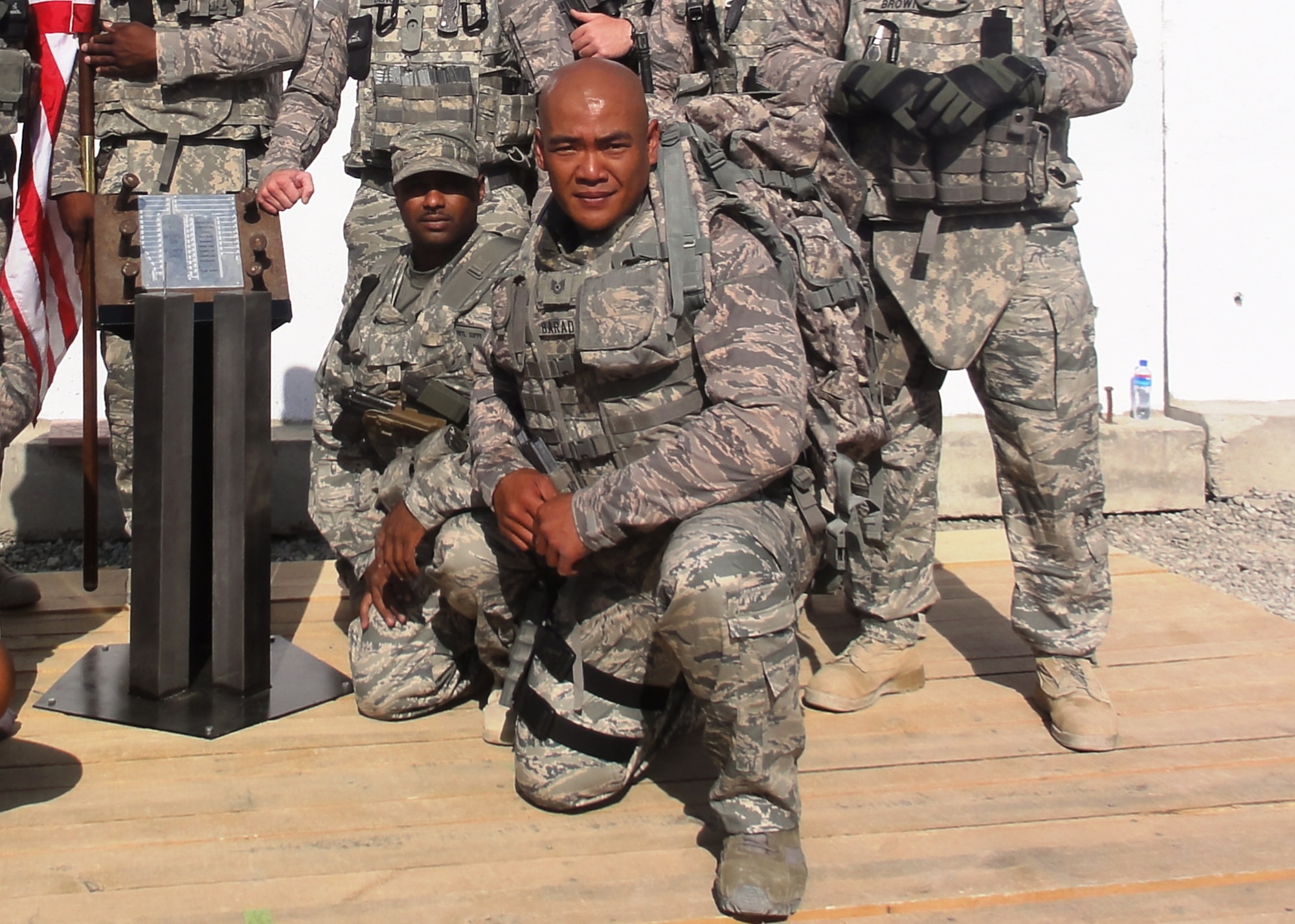 Kabul, Afghanistan -  Tech. Sgt. Darryl Guppy and Tech. Sgt. Arthur Barad kneel at the World Trade Center Dedication Ceremony in Kabul, Afghanistan, which was celebrated by the Tunnel to Towers race Sept 24, 2010.