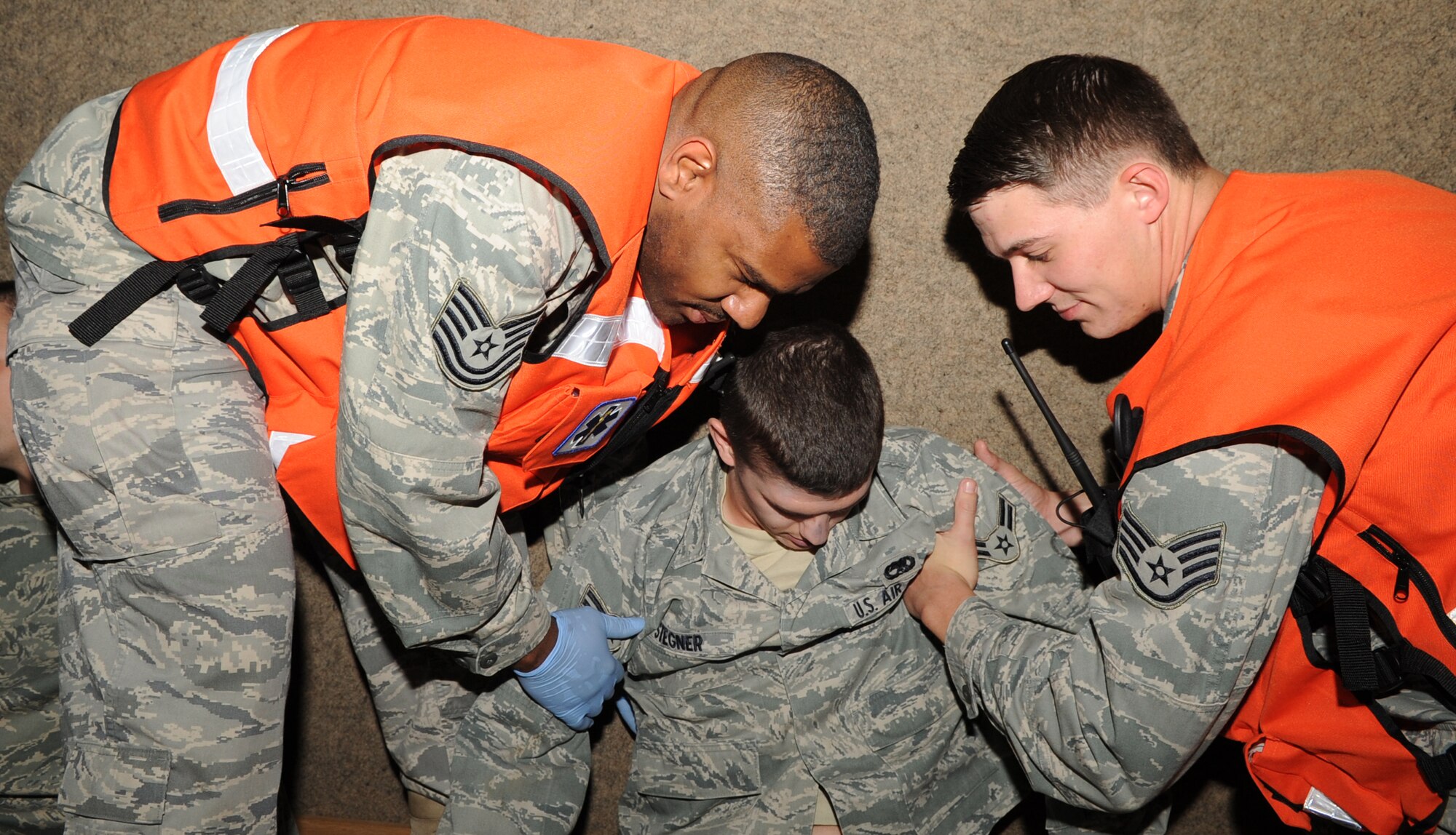 SPANGDAHLEM AIR BASE, Germany – Tech. Sgt. Jamarlon Waller, left, 52nd Medical Operations Squadron NCO in charge of ambulance services, and Staff Sgt. Steven Boone, 52nd MDOS ambulance services craftsman, lay down a simulated casualty during an exercise Oct. 12. The exercise evaluated the wing’s ability to respond to a major accident involving mass casualties. (U.S. Air Force photo/Senior Airman Nick Wilson)