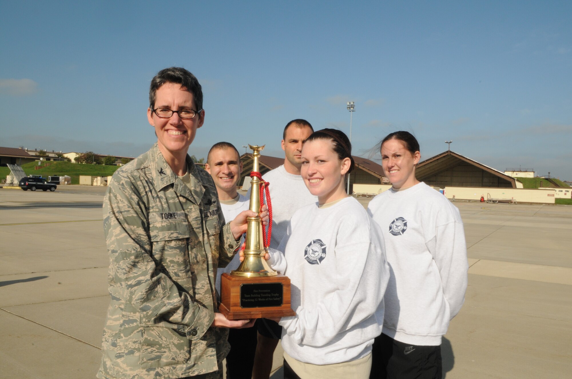 SPANGDAHLEM AIR BASE, Germany – Col. Jodine Tooke, left, 52nd Mission Support Group commander, presents the fire prevention team building traveling trophy to the 52nd Operations Support Squadron “Angry Chickens” team after Spangdahlem’s first ever Fire Muster Challenge as part of Fire Prevention Week Oct. 9. Since 1922, Fire Prevention Week has taken place in the U.S. to increase fire safety awareness. (U.S. Air Force photo/Senior Airman Nick Wilson)