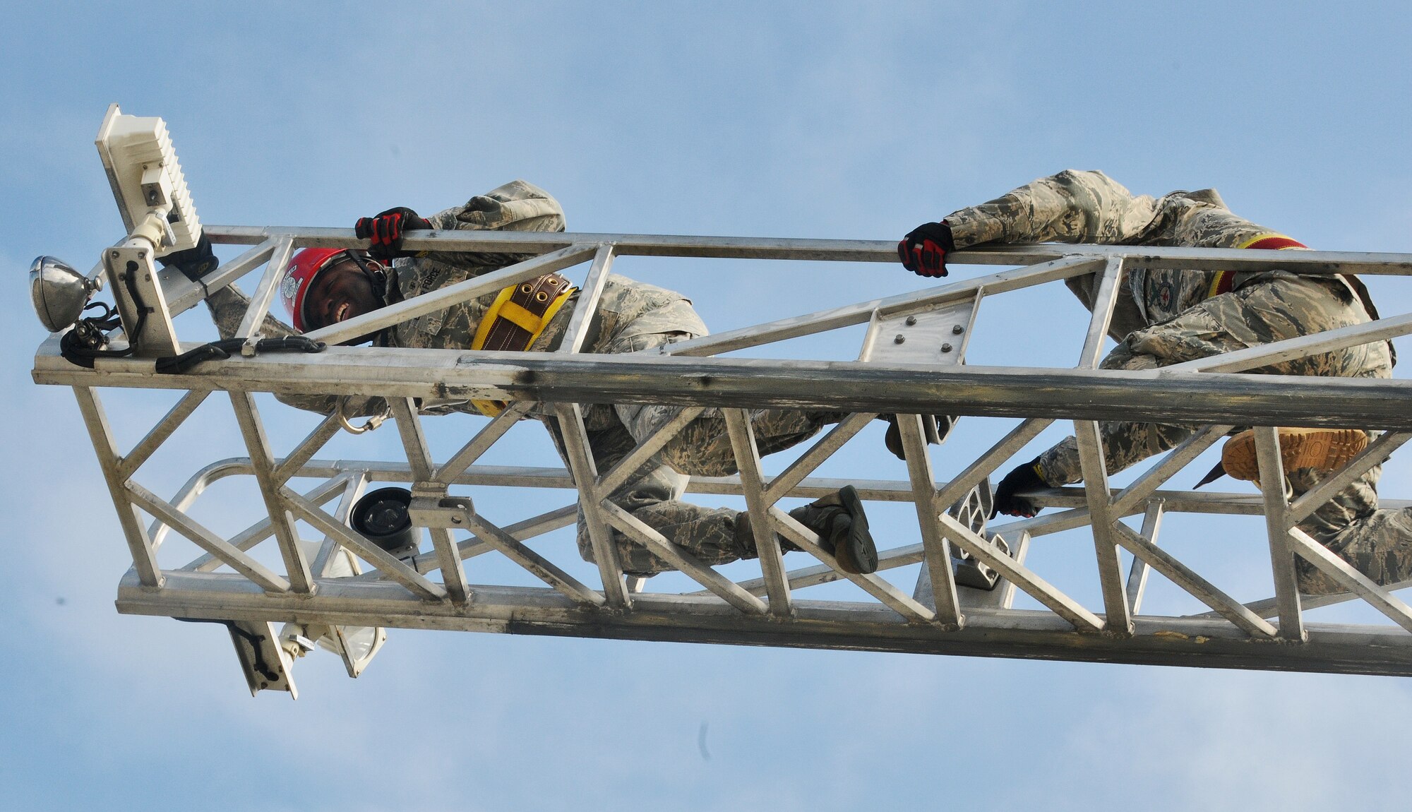 SPANGDAHLEM AIR BASE, Germany – Staff Sgt. David Salley, left, 52nd Medical Operations Squadron “4 Crazies” fire muster team member, climbs to the top of the fire truck ladder with assistance from Airman 1st Class Steven Vandenburg, 52nd Civil Engineer Squadron firefighter, during Spangdahlem’s first ever Fire Muster Challenge as part of Fire Prevention Week Oct. 9. Since 1922, Fire Prevention Week has taken place in the U.S. to increase fire safety awareness. (U.S. Air Force photo/Senior Airman Nick Wilson)