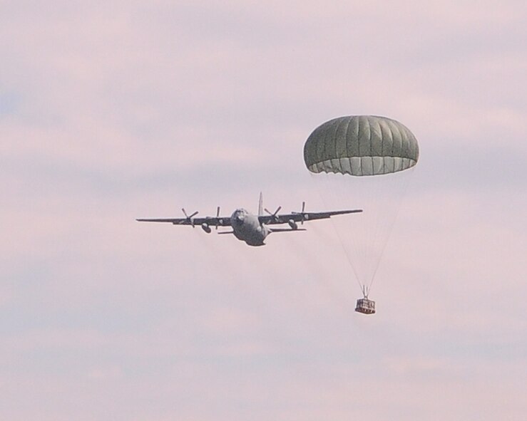 YOKOTA AIR BASE, Japan -- A "round"  parachute carries a cargo load dropped out a C-130 Hercules, down to the Fuji Drop Zone during a practice run of a Low Cost, Low Altitude drop technique, here Oct. 7. (U.S. Air Force Photo/Airman 1st Class Katrina R. Menchaca)