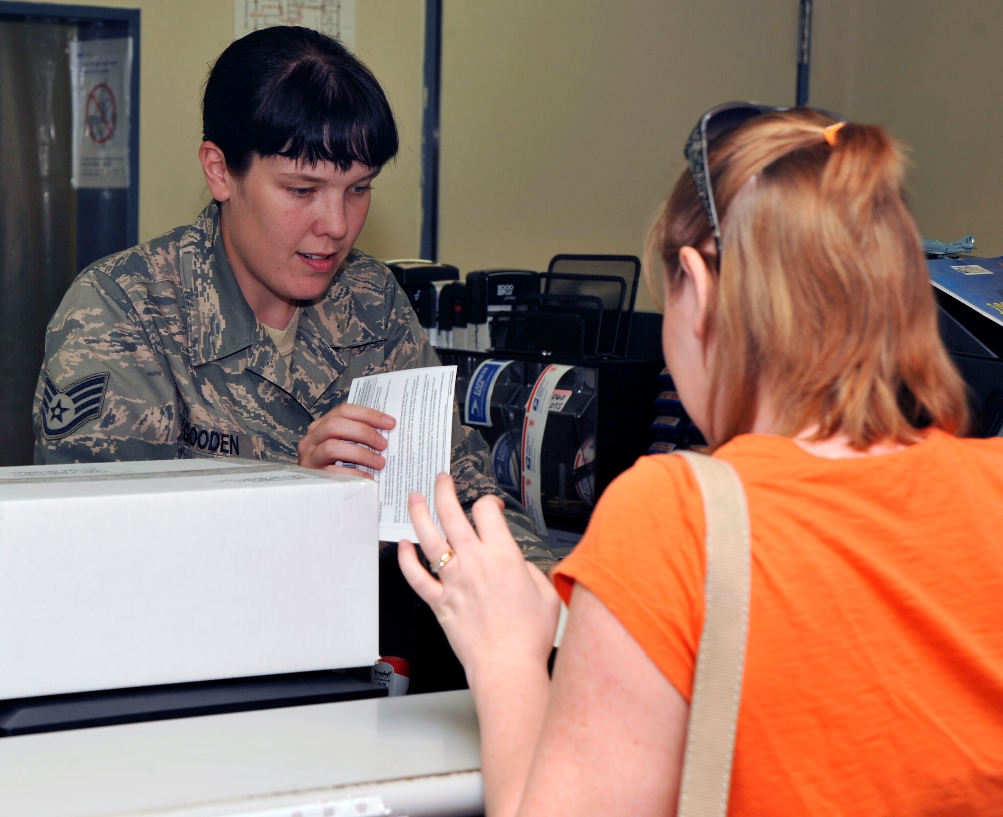 U.S. Air Force Staff Sgt. Celisa Gooden, left, 35th Communications Squadron, assists  a customer with her postage at the service counter at Misawa Air Base, Japan, Oct. 13, 2010. The post office provides service to about 17,000 personnel. (U.S. Air Force photo by Tech. Sgt. Russell McBride/Released)