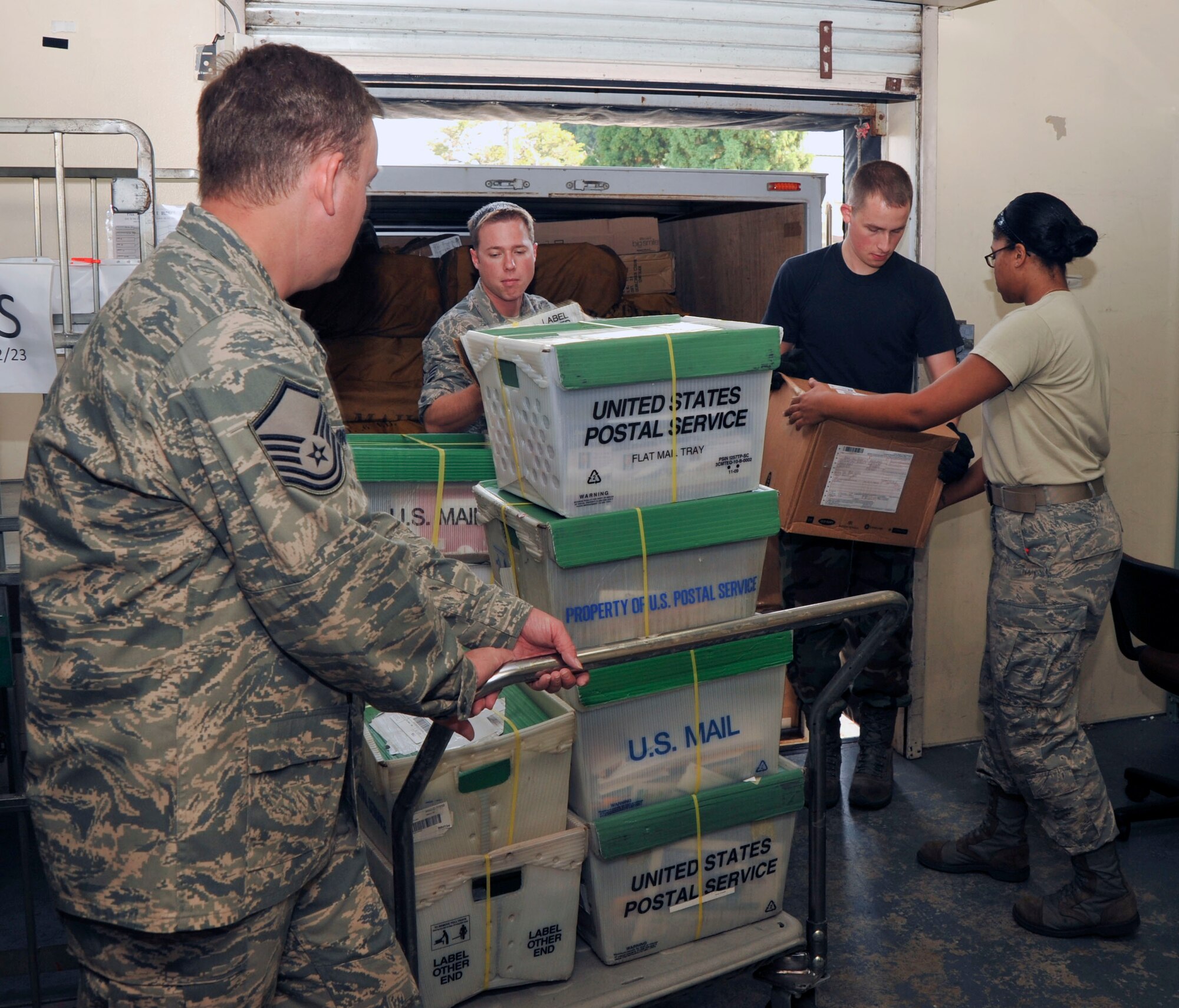 Members of the 35th Communications Squadron postal service center unload the morning mail at Misawa Air Base, Japan, Oct. 13, 2010. The post office receives on average 2000 to 4000 pieces of mail daily. (U.S. Air Force photo by Tech. Sgt. Russell McBride/Released)