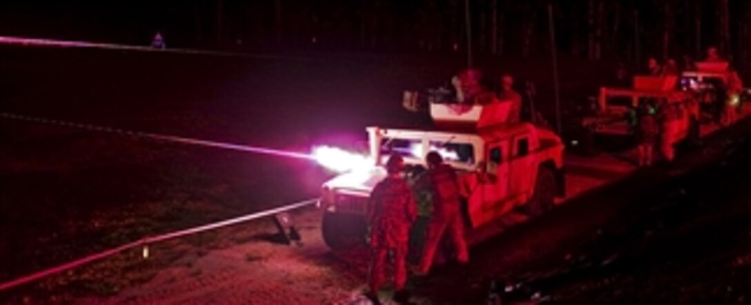 Three teams of Warfighters conduct a night fire during the team weapons skills test on the final night of the Warfighter Challenge.  The 14th Annual Warfighter Challenge at Fort Leonard Wood, Missouri, brings military police units throughout the Army together to determine who is the best in the MP field.  