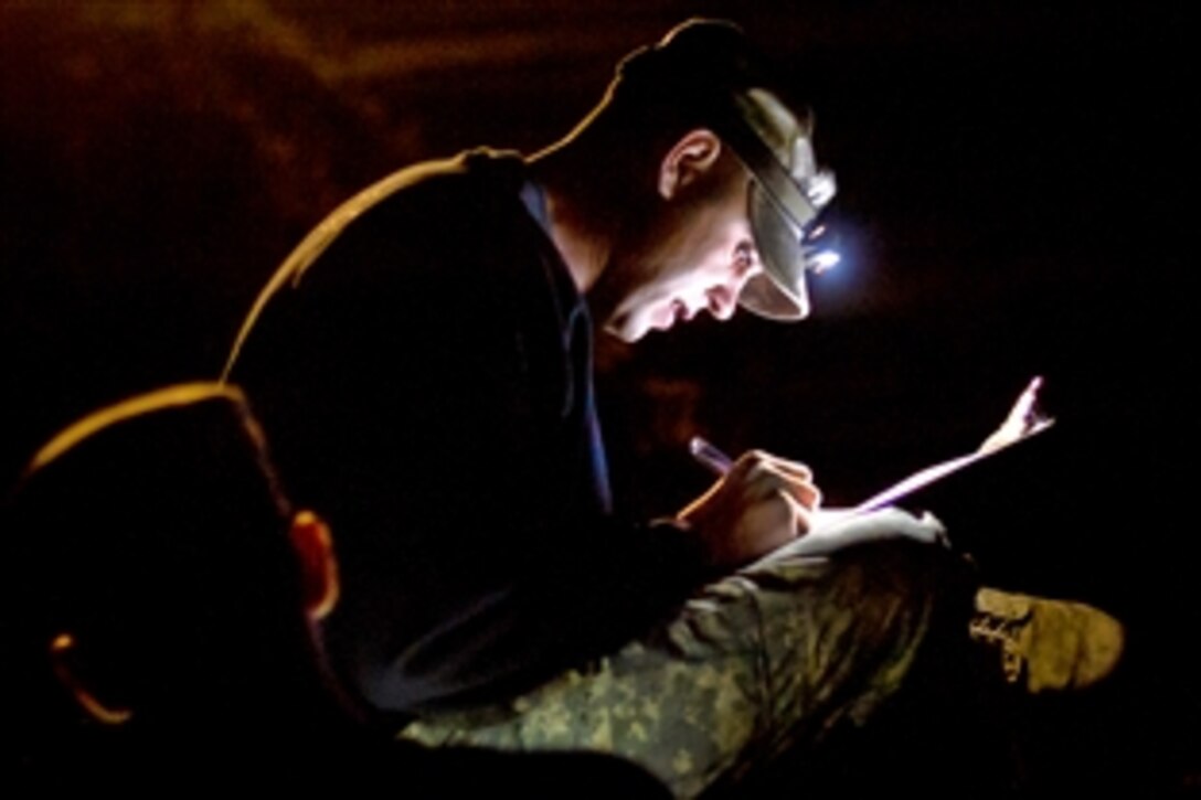 A U.S. Army soldier reads over the shooting scenario for the night target competition during the International Sniper Competition on Selby Hill, Fort Benning, Ga., Oct. 13, 2010. Forces from around the world participated in the competition.