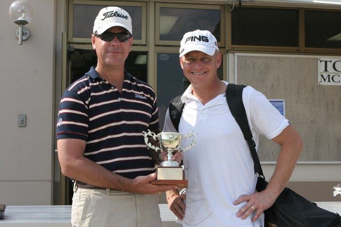 P.J. Kerr claims the Kuni Cup and bragging rights for Marine Aircraft Group 12 at the first ever Kuni Cup Golf Tournament at Torii Pines Golf Course here Oct. 15. MAG-12 took the cup with a combined score of 567 and left Headquarters and Headquarters Squadron begging with a score of 595.­