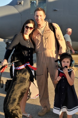 PATRICK AIR FORCE BASE, Fla. - 1st Lt. Patrick Woodruff, HC-130P/N King pilot, 920th Rescue Wing here, piloted a wing aircraft with a crew of 5, all the way from Africa to Florida with 20 Airmen aboard. Upon landing, he was greeted by his wife, Lauren, daughter, Ella, 5, and black labrador retriever, Belle. The Air Force Reservists were deployed to the horn of Africa region were they provided combat search and rescue support. All together 63 Reservists were deployed for 45 days. The Wing is one of the most called upon units in the nation. The Rescue Wing Airmen deploy often supporting combat search and rescue worldwide. (U.S. Air Force Photo/Capt. Cathleen Snow)