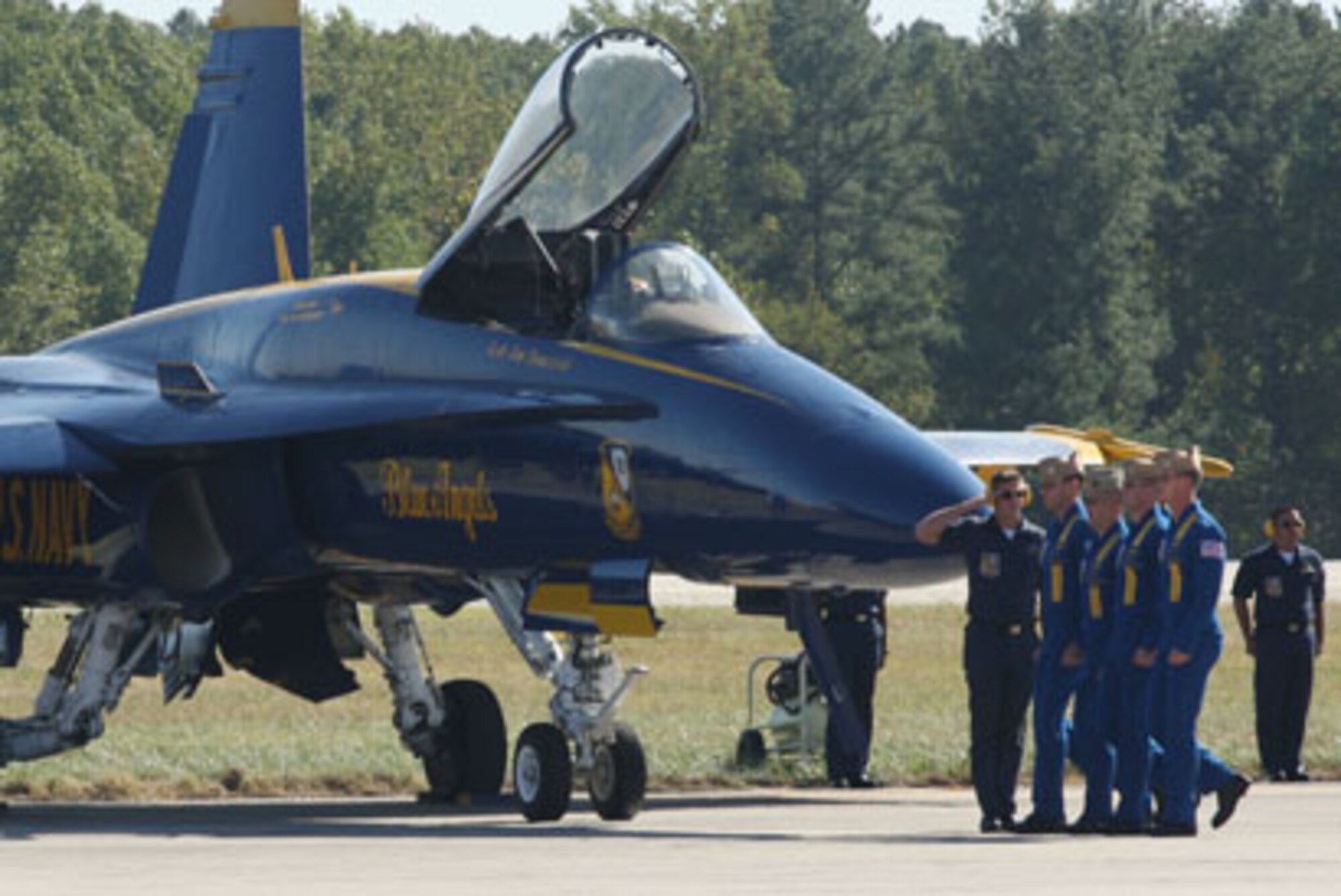Before boarding their aircraft, four Blue Angels pilots step in perfect precision while their crew chiefs salute during the opening ceremonial performance before take-off during the "Wings Over Atlanta 2010 Air Show" practice performance on Oct. 15.  (U.S. Air Force Photo/Don Peek)