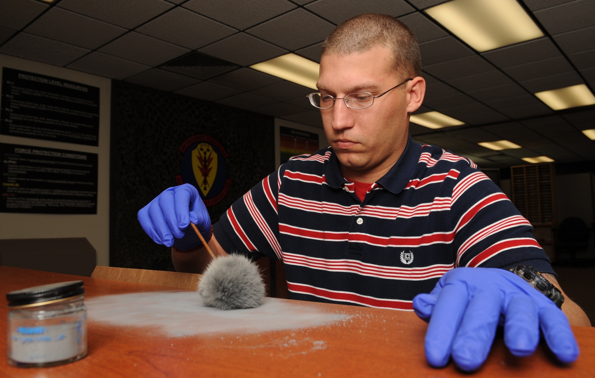 MOUNTAIN HOME AIR FORCE BASE, Idaho -- Staff Sgt Galen Peterson, 366th Security Forces Squadron investigator, dusts for finger prints with a cross match system Sep 22. Security forces provide integrated defense and law enforcement for the base and develop highly trained Airmen to support deployed contingency operations. (U.S. Air Force photo by Senior Airman Roy Lynch)