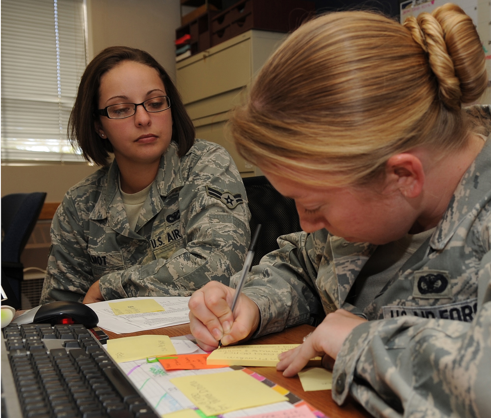 MOUNTAIN HOME AIR FORCE BASE, Idaho -- Airman 1st Class Dannielle Wilmot, 366th Security Forces Squadron defender, waits while Senior Airman Heather Craft, Security Forces Squadron defender, in process’s her Sep 21. Security forces provide integrated defense and law enforcement for the base and develop highly trained Airmen to support deployed contingency operations. (U.S. Air Force photo by Senior Airman Roy Lynch)