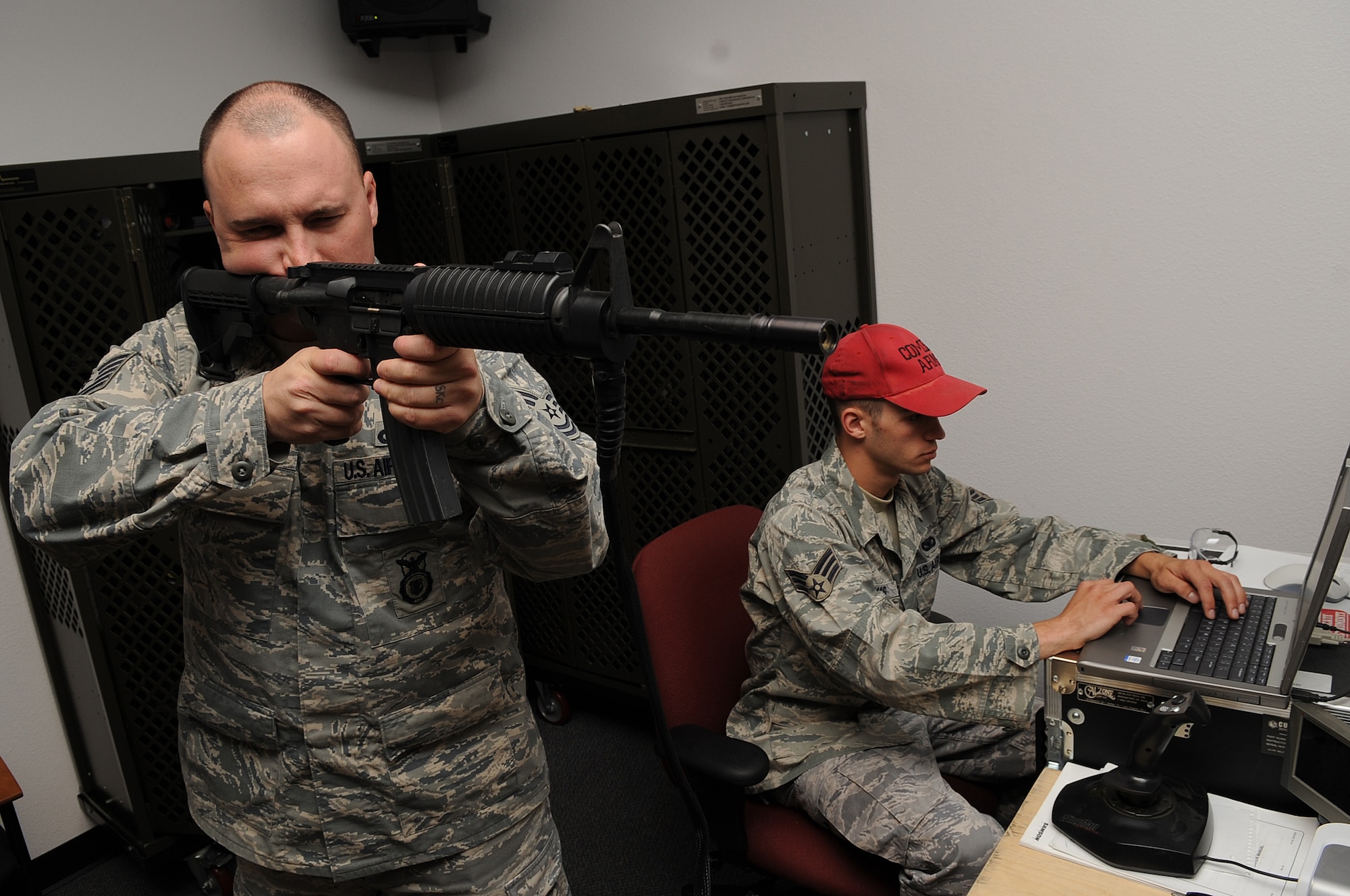 MOUNTAIN HOME AIR FORCE BASE, Idaho -- Tech Sgt Otis Chatham, 366th Security Forces Squadron defender, fires an M-16 while Senior Airman Richard Thomas, 366th Security Forces Squadron defender, controls the firearm training simulator at the combat arms range Sep 21. Security forces provide integrated defense and law enforcement for the base and develop highly trained Airmen to support deployed contingency operations. (U.S. Air Force photo by Senior Airman Roy Lynch)