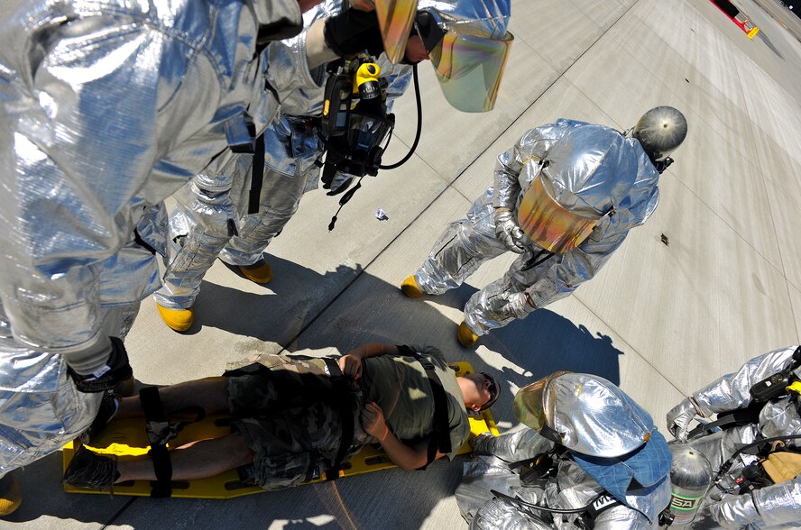MOODY AIR FORCE BASE, Ga. -- Airmen from the 23rd Civil Engineer Squadron emergency services flight surround a moulage victim wounded during a Major Accident Response Exercise here Oct. 15. The scenario involved a large-framed aircraft completing a bank turn during a flying demonstration when it experienced terminal engine failure and crashed into a static display, causing more than 100 casualties and fatalities. (U.S. Air Force photo/Airman 1st Class Joshua Green)


