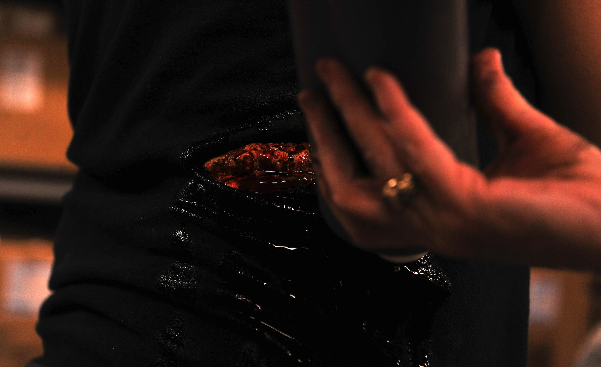 MOODY AIR FORCE BASE, Ga. -- Fake blood is placed on a wound created from a moulage kit before a Major Accident Response Exercise here Oct. 15. The exercise was designed to prepare the 23rd Medical Group, base agencies and off-base agencies for the upcoming Community Appreciation Day Airshow Nov. 13 in the event of a plane crash. (U.S. Air Force photo/Airman 1st Class Joshua Green)
