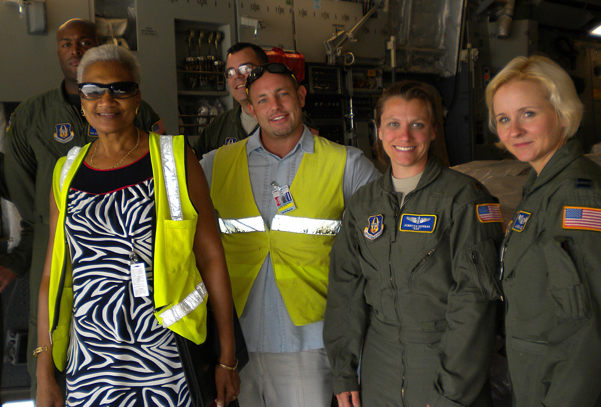 JOINT BASE LEWIS-MCCHORD, Wash., - Maj. Jenniver Hrivnak 97th Airlift Squadron (second to left) and Capt. Laura Ely, 446th Aeromedical Evacuation Squadron, took part in a humanitarian mission Aug. 21 to Jamica. The training mission picked up three pallets of medical supplies and delivered them to the Ministry of Health Hospital in Jamaica. (Courtesy photo)