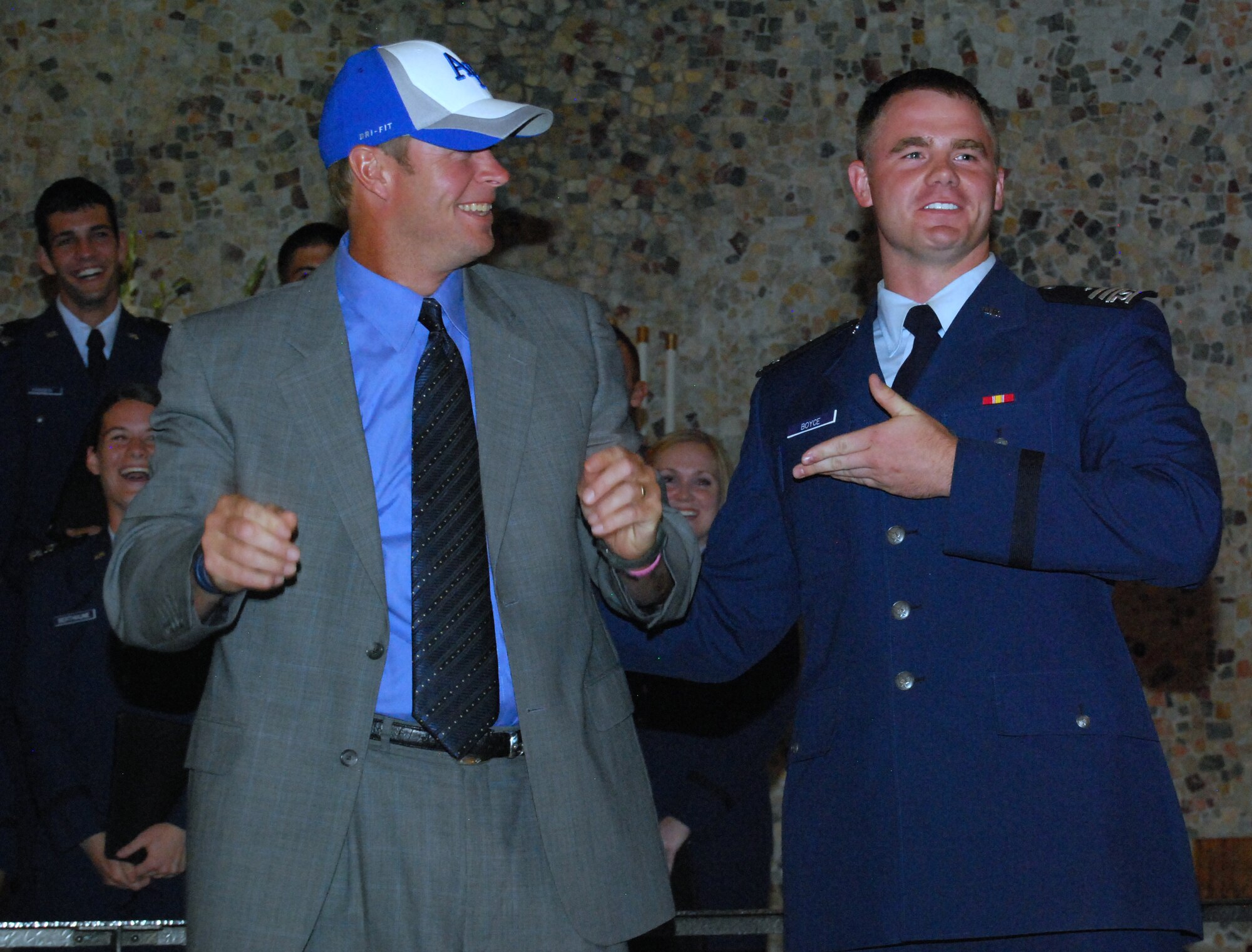 Cadet 1st Class Brett Boyce, right, thanks BYU football head coach Bronco Mendenhall for leading a Mormon worship service in the Air Force Academy's Cadet Chapel the evening of Sept. 10, 2010. The cadet chorus presented the Cougars coach with an Air Force Falcons hat as a gift for leading the service. (U.S. Air Force photo/Staff Sgt. Don Branum)