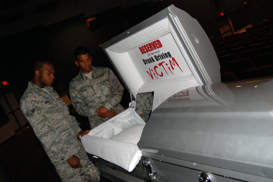 Airman 1st Class Antonio Martin and Airman Basic Nathan Colon, 365th Training Squadron, peer into an empty casket Oct. 14 after attending the Save-a-Life presentation at the base theater.  The tour, sponsored by the 82nd Training Wing Safety Office, focused on the potentially deadly affects of drinking and driving.  About 1,000 Team Sheppard members attended the seminars. (U.S. Air Force photo/Mike McKito)
