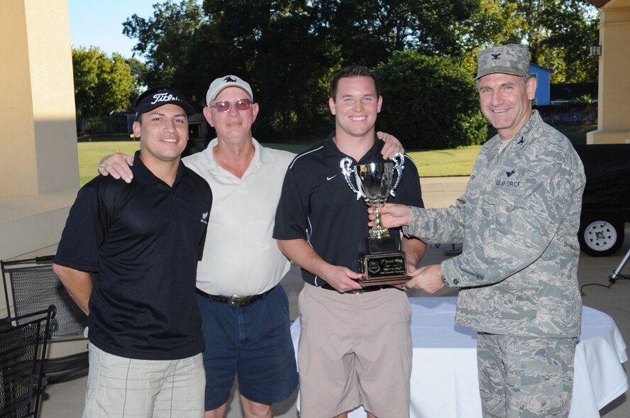 BARKSDALE AIR FORCE BASE, La. -- Col. Tim Fay, 2d Bomb Wing commander, presents members of the 2BW and 2nd Comptroller Squadron with their trophy at the first Best of the Wing Golf Scramble Oct. 14. Colonel Fay held the tournament to determine which squadron has the best golf team. (U.S. Air Force photo/Airman 1st Class Sean Martin)(Released)