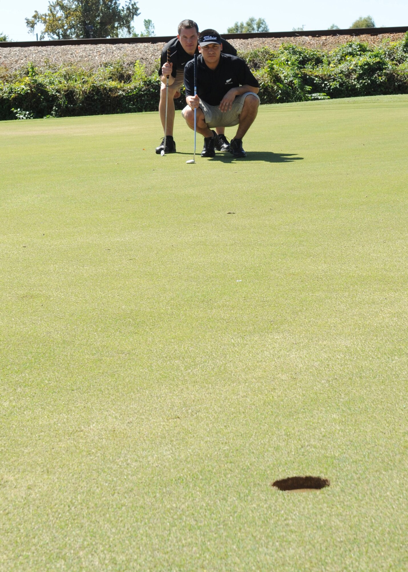 BARKSDALE AIR FORCE BASE, La. -- Members from the 2nd Comptroller Squadron line up a putt during the first Best of the Wing Golf Scramble Oct. 14. Col. Tim Fay, 2nd Bomb Wing commander, held the tournament to determine which squadron has the best golf team.  (U.S. Air Force photo/Airman 1st Class Sean Martin)(Released)