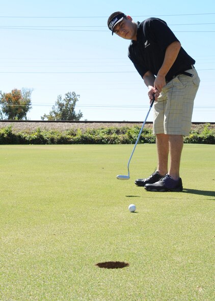 BARKSDALE AIR FORCE BASE, La. -- Airman 1st Class Joseph Senteno, 2nd Comptroller Squadron, putts a ball during the first Best of the Wing Golf Scramble Oct. 14. Col. Tim Fay, 2nd Bomb Wing commander, held the tournament to determine which squadron has the best golf team.(U.S. Air Force photo/Airman 1st Class Sean Martin)(Released)