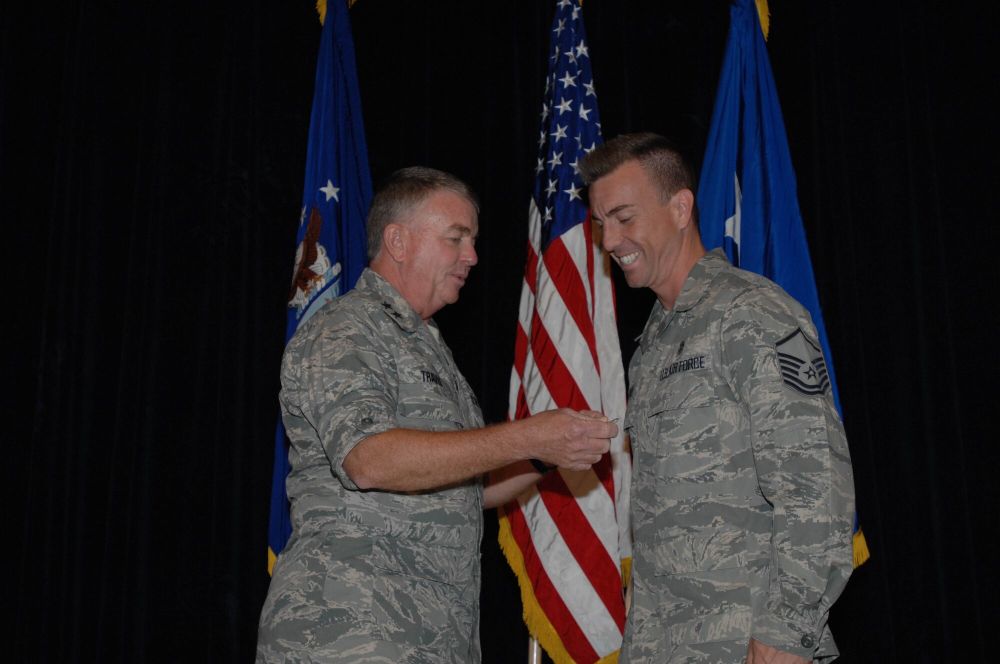 Maj. Gen. Tom Travis, 59th Medical Wing commander (left), presents the Bronze Star to Master Sgt. William Rapoza, NCO-in-charge of medical readiness training, 59th Medical Support Squadron, at Wilford Hall Medical Center Oct. 14. Sergeant Rapoza received the award for medical support of operations outside the wire, while serving as the lead medic, Detachment 2, 232nd Expeditionary Security Forces Squadron, United States Forces-Iraq, Baghdad, Iraq, from Jan. 21, 2010 to July 31, 2010.  The Bronze Star is awarded to military personnel who distinguish themselves by heroic or meritorious achievement or service, not involving participation in aerial flight, in connection with military operations against an armed enemy.  (U.S. Air Force photo/Staff Sgt. Robert Barnett)