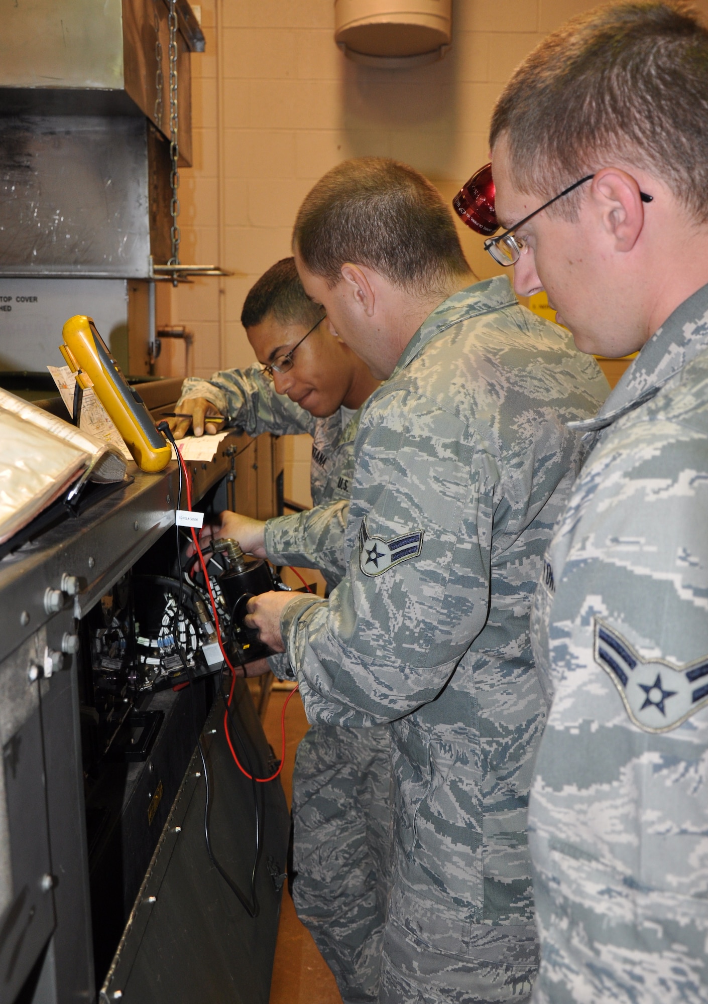 Airmen in Training from the 361st Training Squadron, Airman 1st Class Edward Fowke (front), Airman 1st Class Robert McLeor (middle) and Airman Gerald Santana trouble shoot a Dash-60 gas turbine engine during block 10 of the Aerospace Ground Equipment technician course Oct. 5. AGE technicians support the Air Force mission with their expertise of maintaining, fixing and troubleshooting flightline equipment at Air Force bases worldwide. (U.S. Air Force photo/Airman 1st Class Adawn Kelsey)