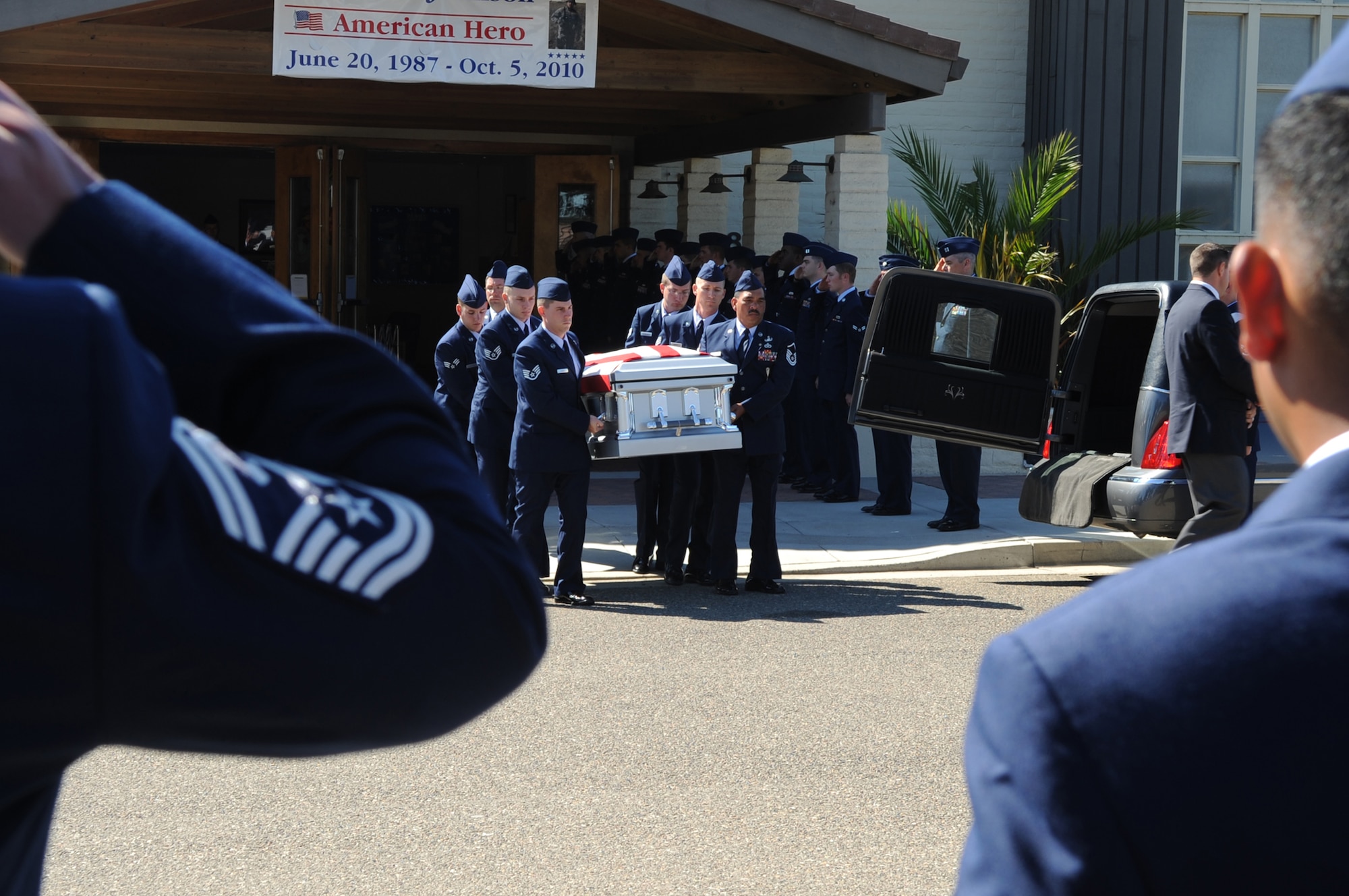 Airmen salute as Senior Airman Daniel Johnson's casket is transferred from a memorial service to another service for the fallen Airman Oct. 13, 2010, in Santa Maria, Calif. Airman Johnson, a 30th Civil Engineer Squadron explosive ordnance disposal flight technician, was killed in the line of duty Oct. 5, 2010, in Kandahar, Afghanistan. (U.S. Air Force photo/Airman 1st Class Lael Huss)