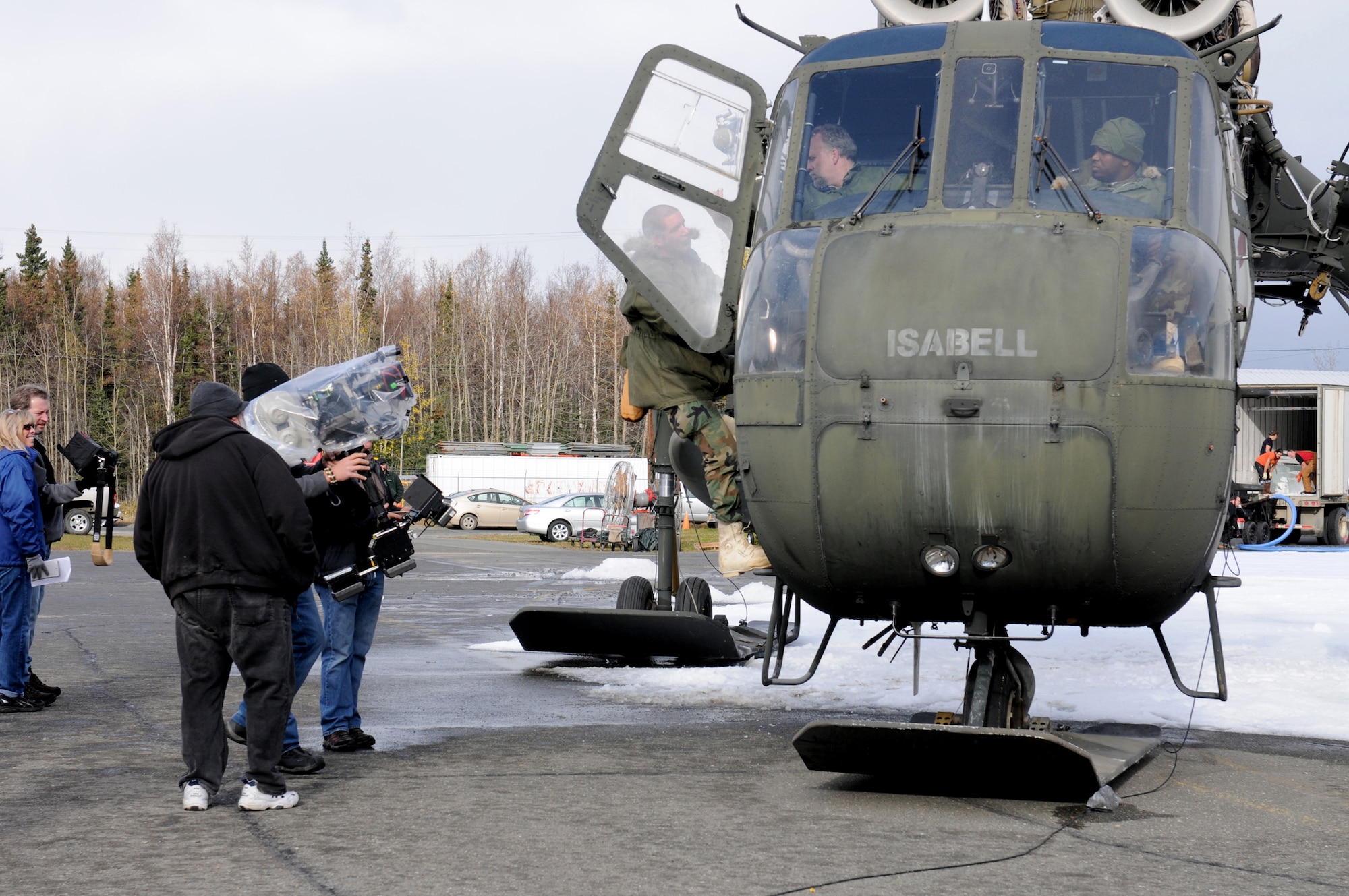 An Alaska Army National Guardsman acting as a stand-in for the upcoming movie “Everybody Loves Whales” is seen climbing the ladder of a CH-54 Sky Crane helicopter during filming at Bryant Army Airfield, October 4. Stand-ins are used as temporary replacements for stars providing the production crew a chance to rehearse. (ANG photo/Pfc. Karina Paraoan)