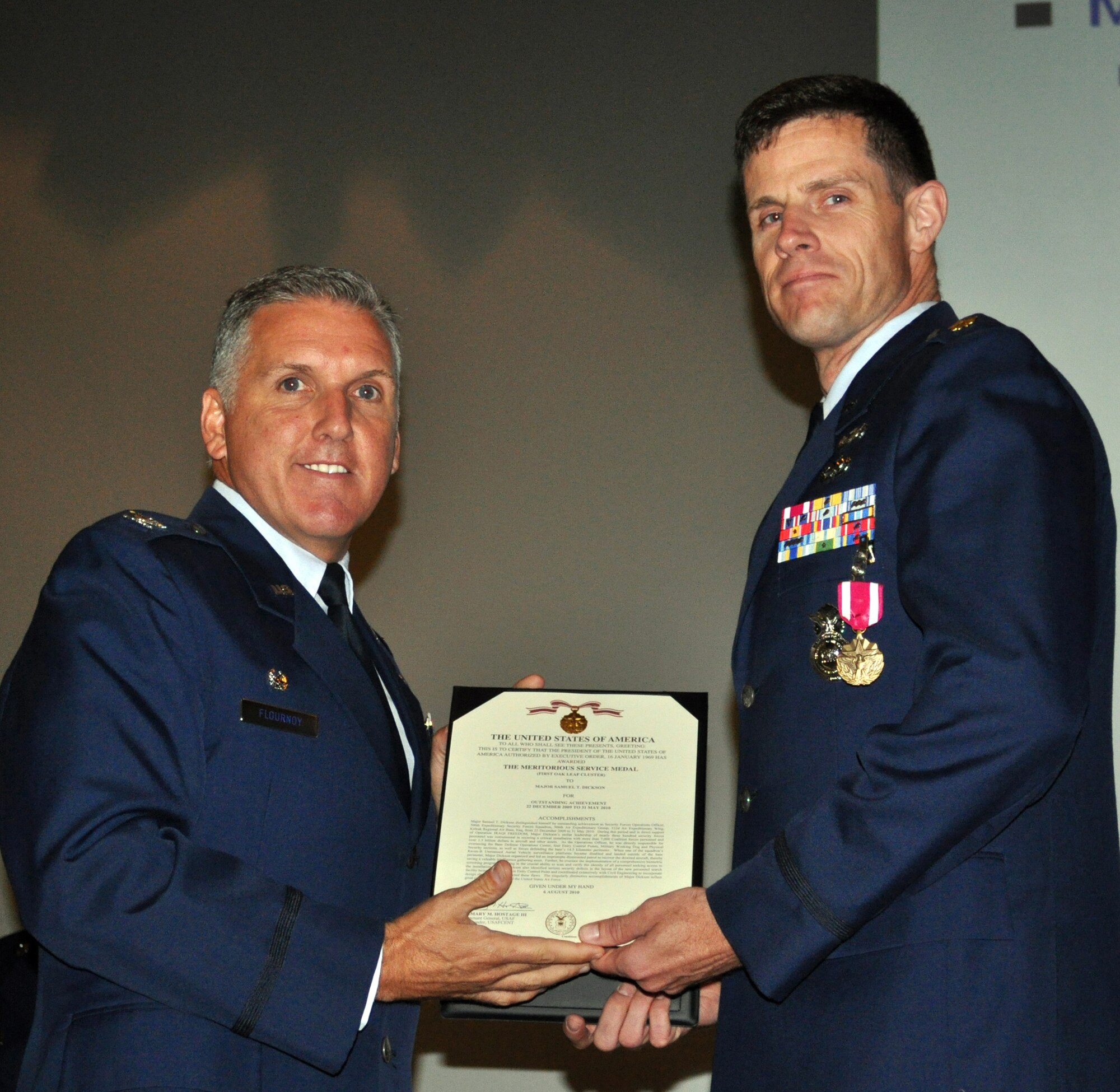 TRAVIS AIR FORCE BASE, Calif. -- The 349th Air Mobility Wing kicked off fiscal year 2011 with a Wing Commander's Call. Col. Jay Flournoy, wing commander, presented the Meritorious Service medal to Maj. Samuel Dickson, 349th Security Forces Squadron commander. (U.S. Air Force photo/Senior Master Sgt. Jeffrey Rachal)