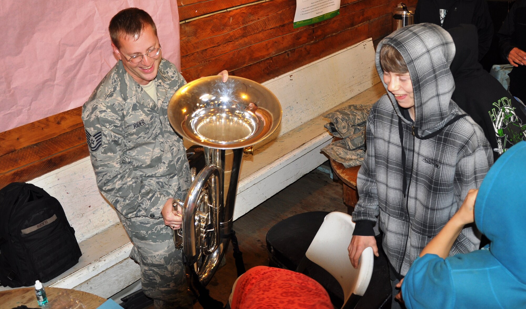 Tech. Sgt. John Rider, Alaska Brass NCOIC, shares a laugh with young residents of Huslia. (U.S. Air Force photo/TSgt John Rider)