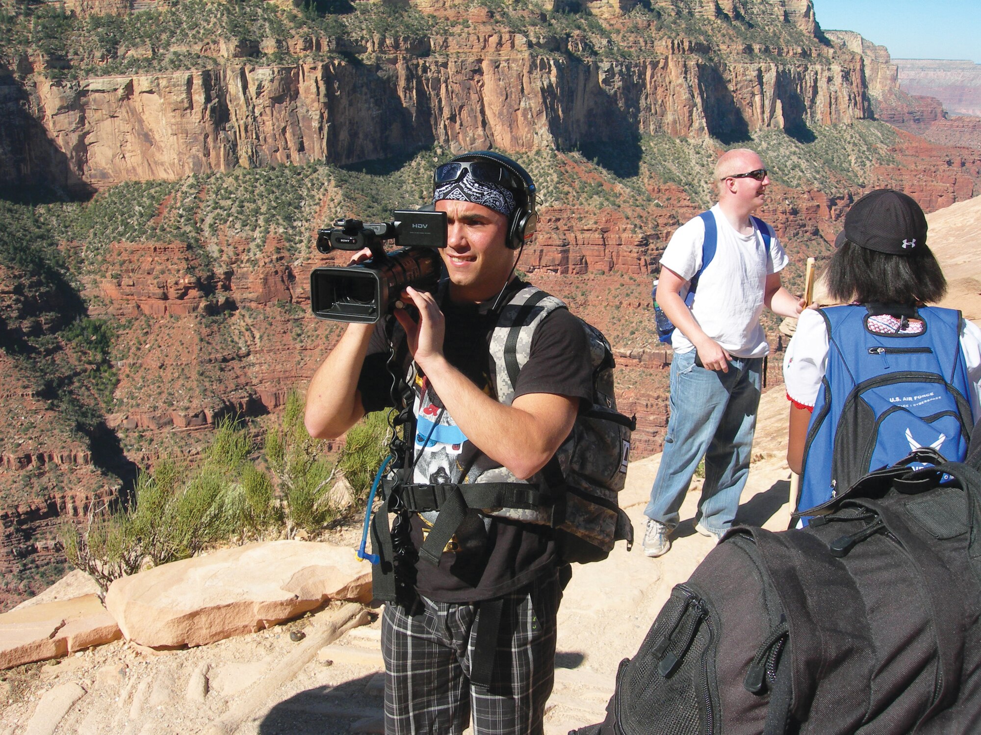 Airman 1st Class Roman Weber, 56th Fighter Wing Public Affairs broadcaster, records footage of Grand Canyon and the Airmen while hiking.  (Courtesy photo)