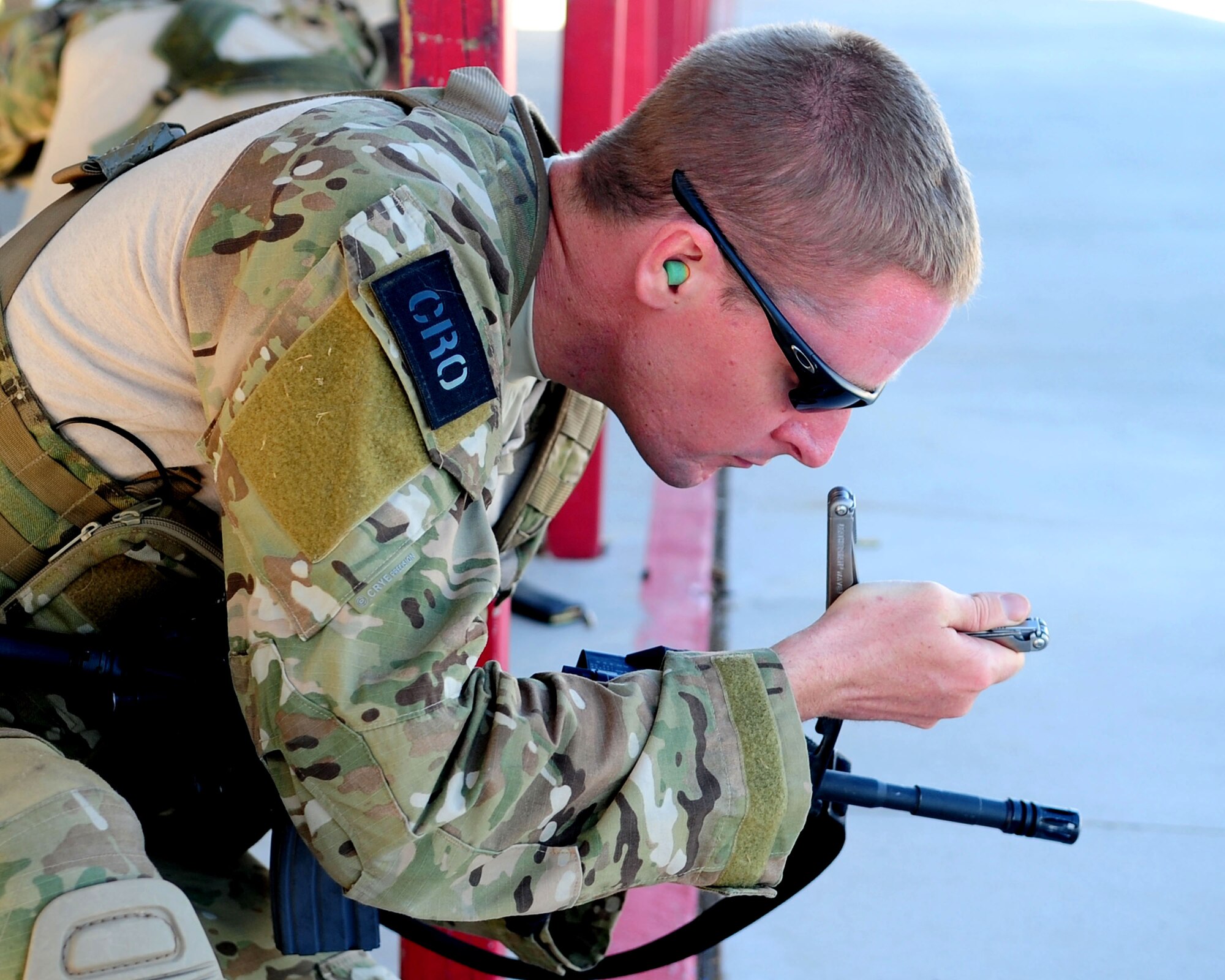 DAVIS-MONTHAN AIR FORCE BASE, Ariz. - Staff Sgt. Joel Mack, a pararescueman from the 304th Rescue Squadron, adjusts the sights of his M-16 prior to the weapons employment portion of the PJ Rodeo competition here Oct. 8, 2010. (U.S. Air Force photo/Airman 1st Class Jerilyn Quintanilla)