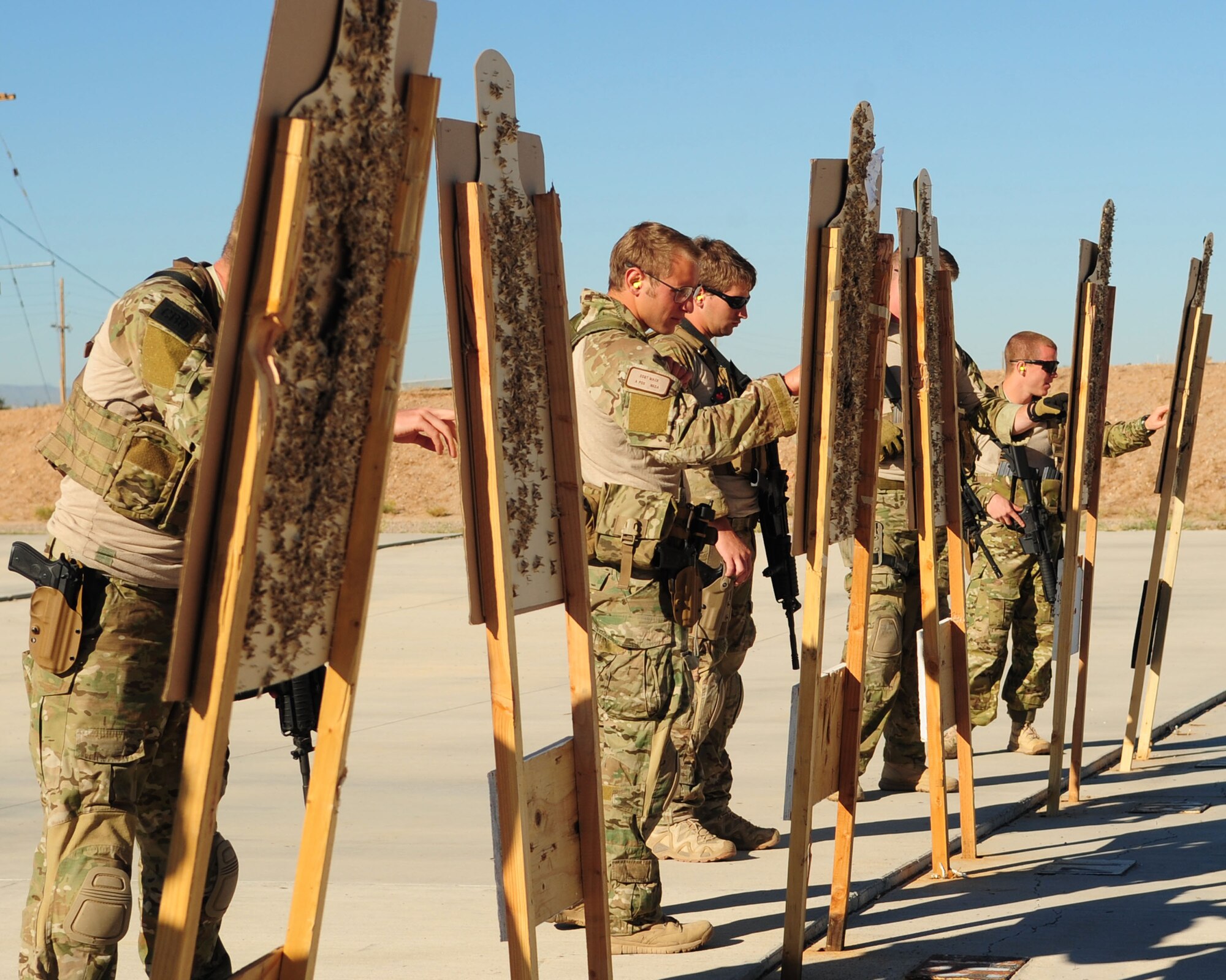 DAVIS-MONTHAN AIR FORCE BASE, Ariz. - Pararescuemen participating in the bi-annual PJ Rodeo competition check their target boards during the rifle and pistol marksmanship challenge here Oct. 8, 2010. Seven pararescue teams from across the nation took part in the competition designed to test field and survival skills essential as rescue specialists. (U.S. Air Force photo/Airman 1st Class Jerilyn Quintanilla)