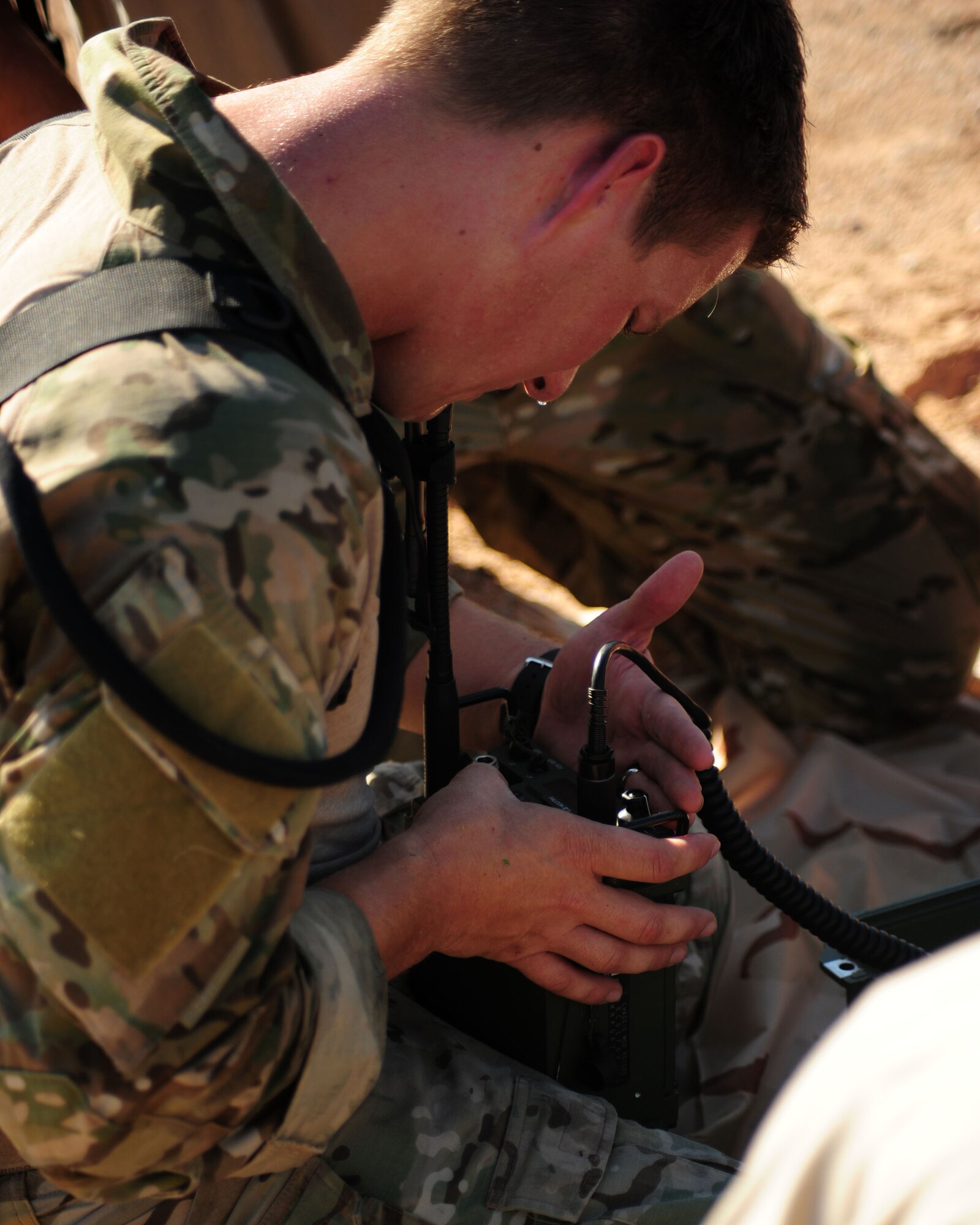 DAVIS-MONTHAN AIR FORCE BASE, Ariz. - A Pararescueman participating in the bi-annual PJ Rodeo competition troubleshoots a radio during a communications outage scenario here Oct. 7, 2010. (U.S. Air Force photo/Airman 1st Class Jerilyn Quintanilla)