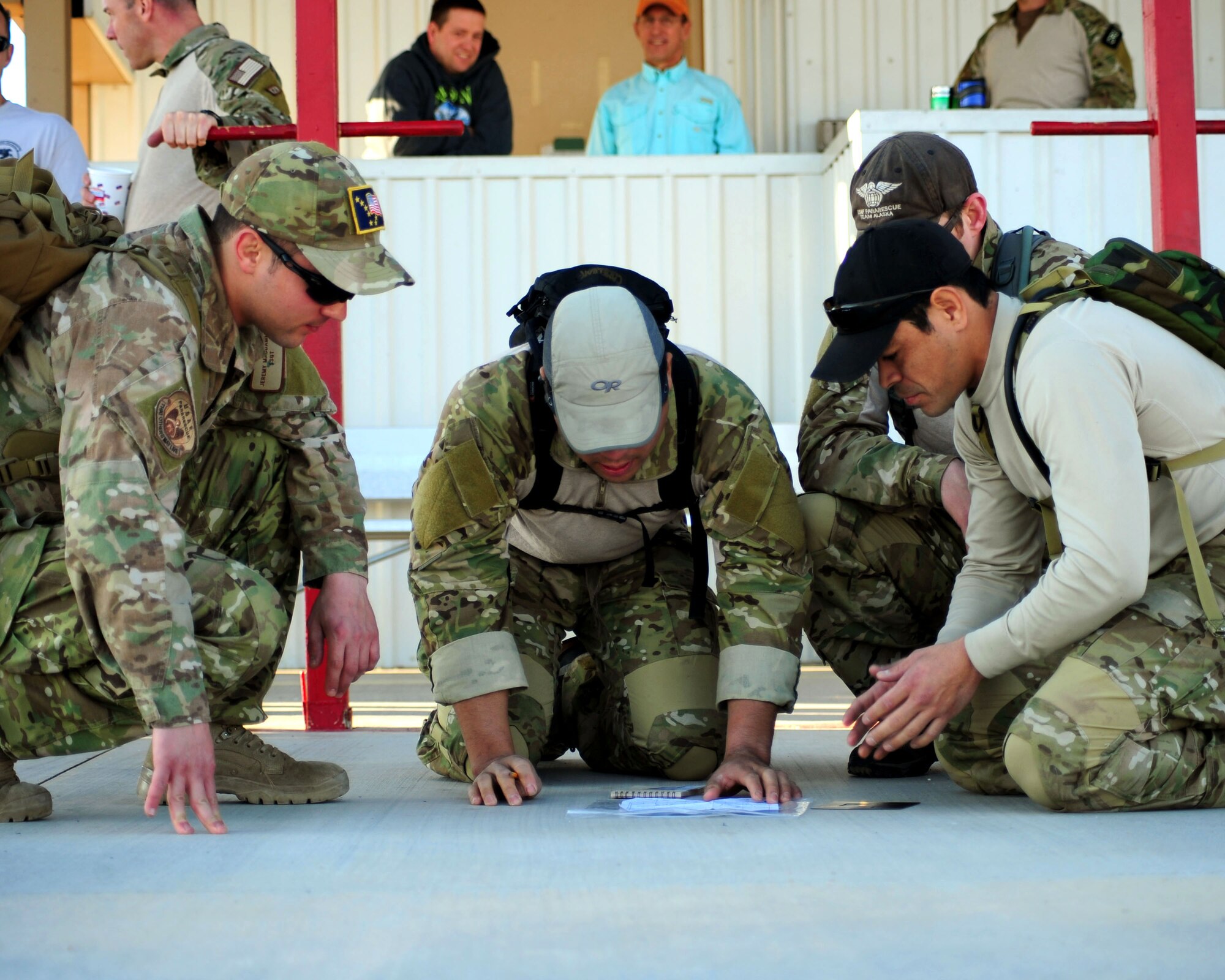 DAVIS-MONTHAN AIR FORCE BASE, Ariz. - Pararescuemen from the 212th Rescue Squadron based in Anchorage, Alaska, plan their route prior to departing for an eight-mile land navigation challenge as part of the bi-annual PJ Rodeo competition here Oct. 7, 2010. (U.S. Air Force photo/Airman 1st Class Jerilyn Quintanilla)