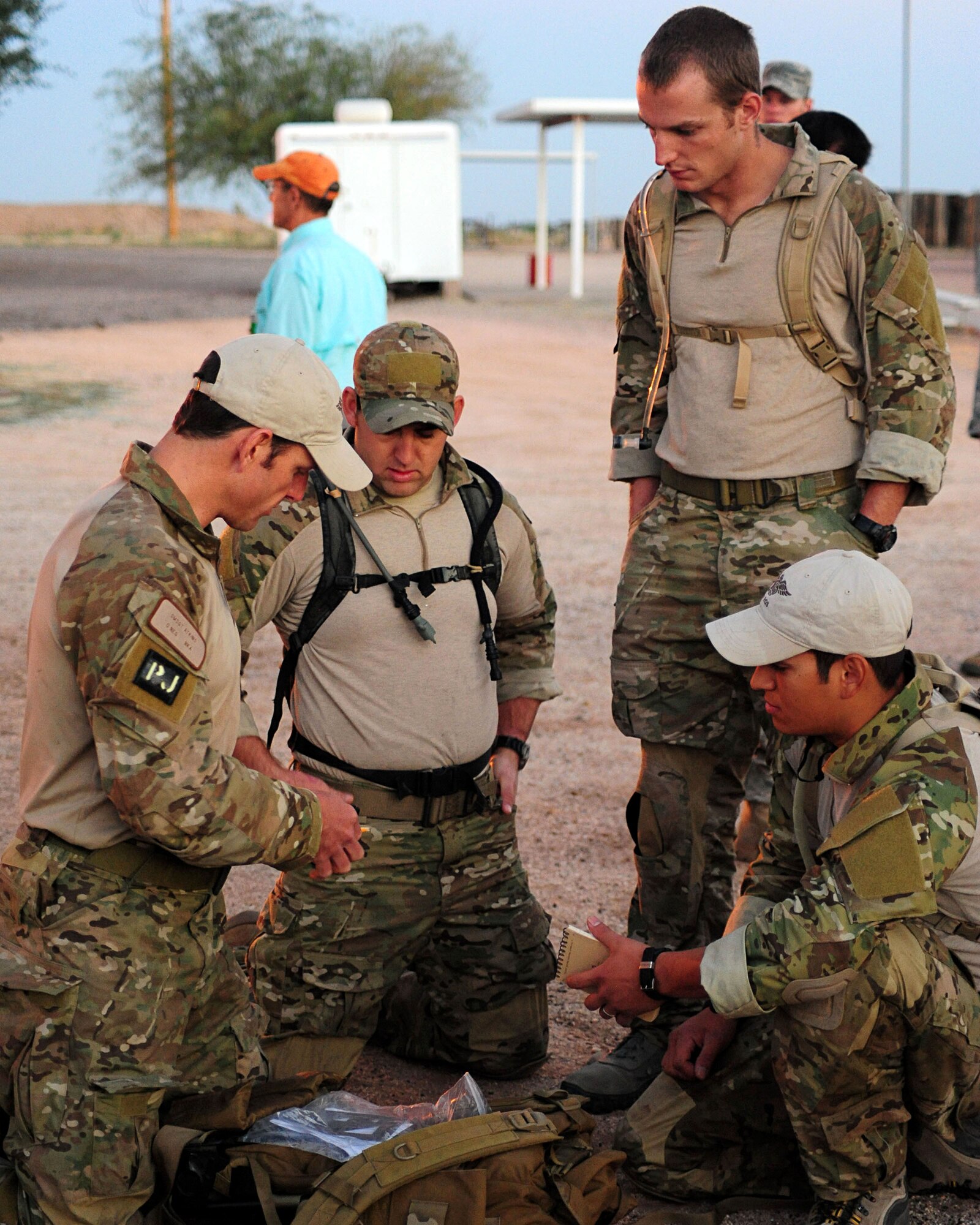 DAVIS-MONTHAN AIR FORCE BASE, Ariz. - Pararescuemen from the 48th Rescue Squadron familiarize themselves with tools and materials given to them prior to departing for an eight-mile land navigation challenge as part of the bi-annual PJ Rodeo competition here Oct. 7, 2010. (U.S. Air Force photo/Airman 1st Class Jerilyn Quintanilla)