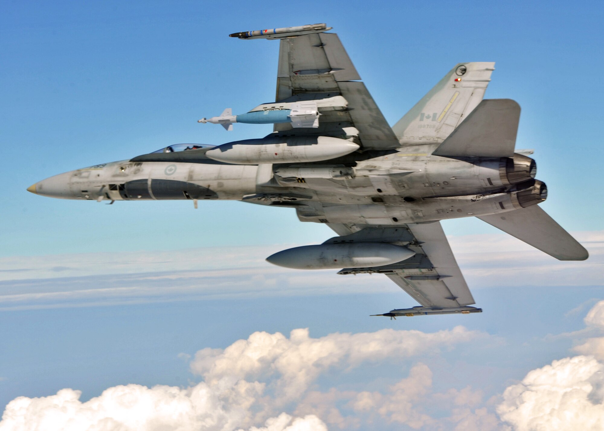 A Canadian Air Force CF-18 flies over the Eglin Air Force Base range during an air-to-ground Weapons System Evaluation mission.  The 86th Fighter Weapons Squadron conducts the WSEP program at Eglin.  The WSEP program is used to evaluate the effectiveness and suitability of combat air force weapon systems. The evaluations are accomplished during tactical deliveries of fighter, bomber and unmanned aerial system precision guided munitions, on realistic targets with air-to-air and surface-to-air defenses. For many of the aircrew participating in WSEP, it is the first time employing live weapons. This provides a level of combat experience many units face during combat. Courtesy photo.