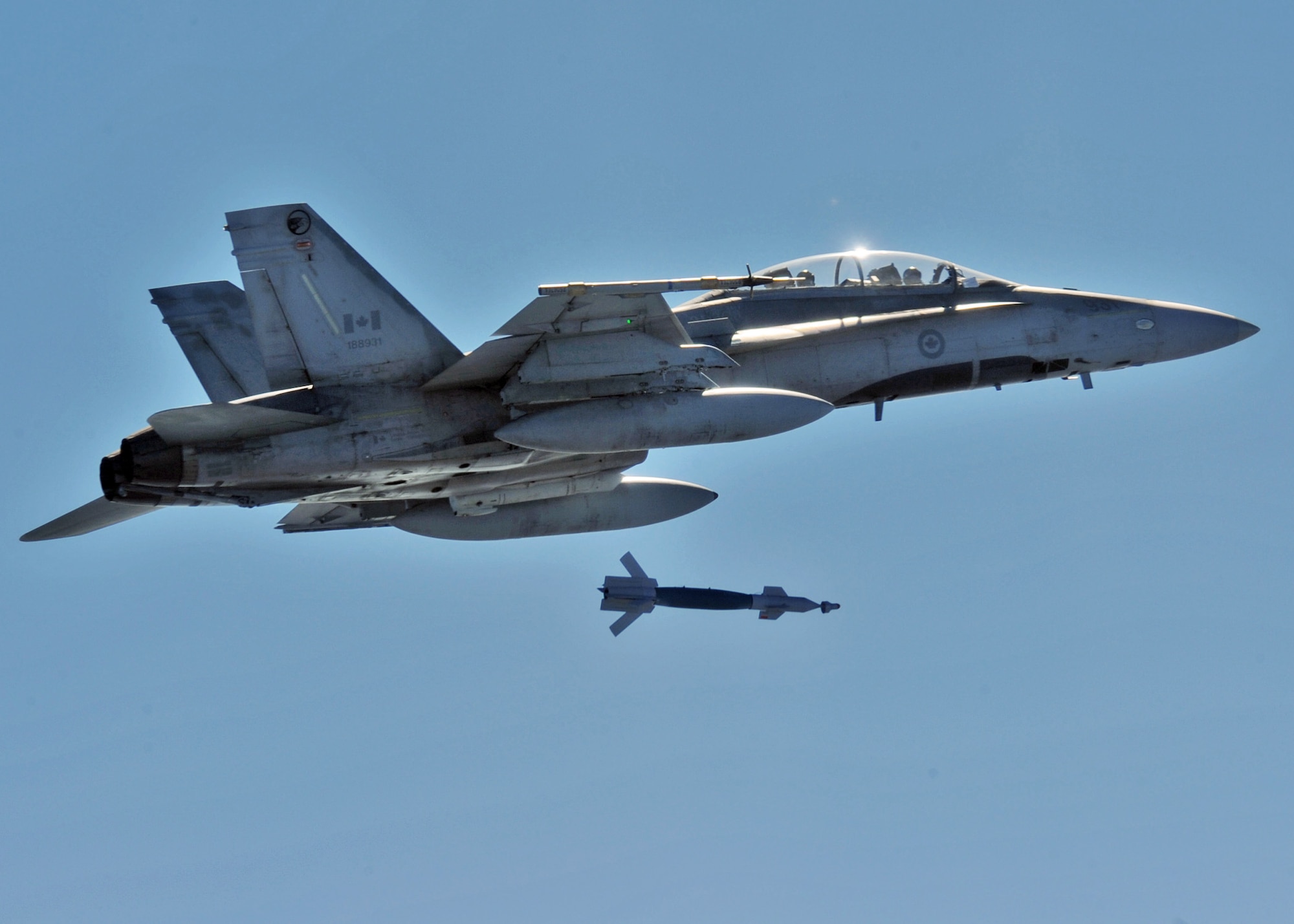 A Canadian Air Force CF-18 releases a Guided Bomb Unit-12 over the Eglin Air Force Base range during an air-to-ground Weapons System Evaluation mission.  The 86th Fighter Weapons Squadron conducts the WSEP program at Eglin.  The WSEP program is used to evaluate the effectiveness and suitability of combat air force weapon systems. The evaluations are accomplished during tactical deliveries of fighter, bomber and unmanned aerial system precision guided munitions, on realistic targets with air-to-air and surface-to-air defenses. For many of the aircrew participating in WSEP, it is the first time employing live weapons. This provides a level of combat experience many units face during combat. Courtesy photo.