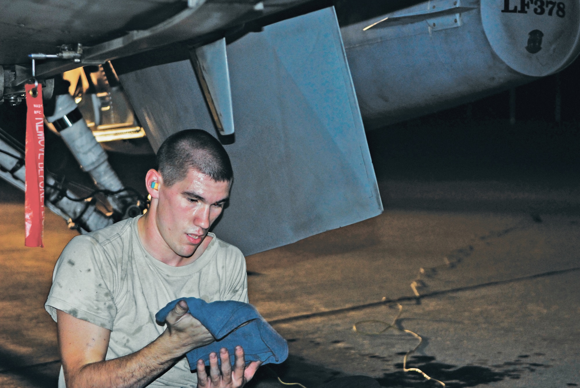 Airman 1st Class Joshua Gorman, 756th Aircraft Maintenance Squadron crew chief, prepares to wash the underside of an F-16 Fighting Falcon leaving on a cross-country trip in the morning. (U.S. Air Force photo/Senior Airman C.J. Hatch)
