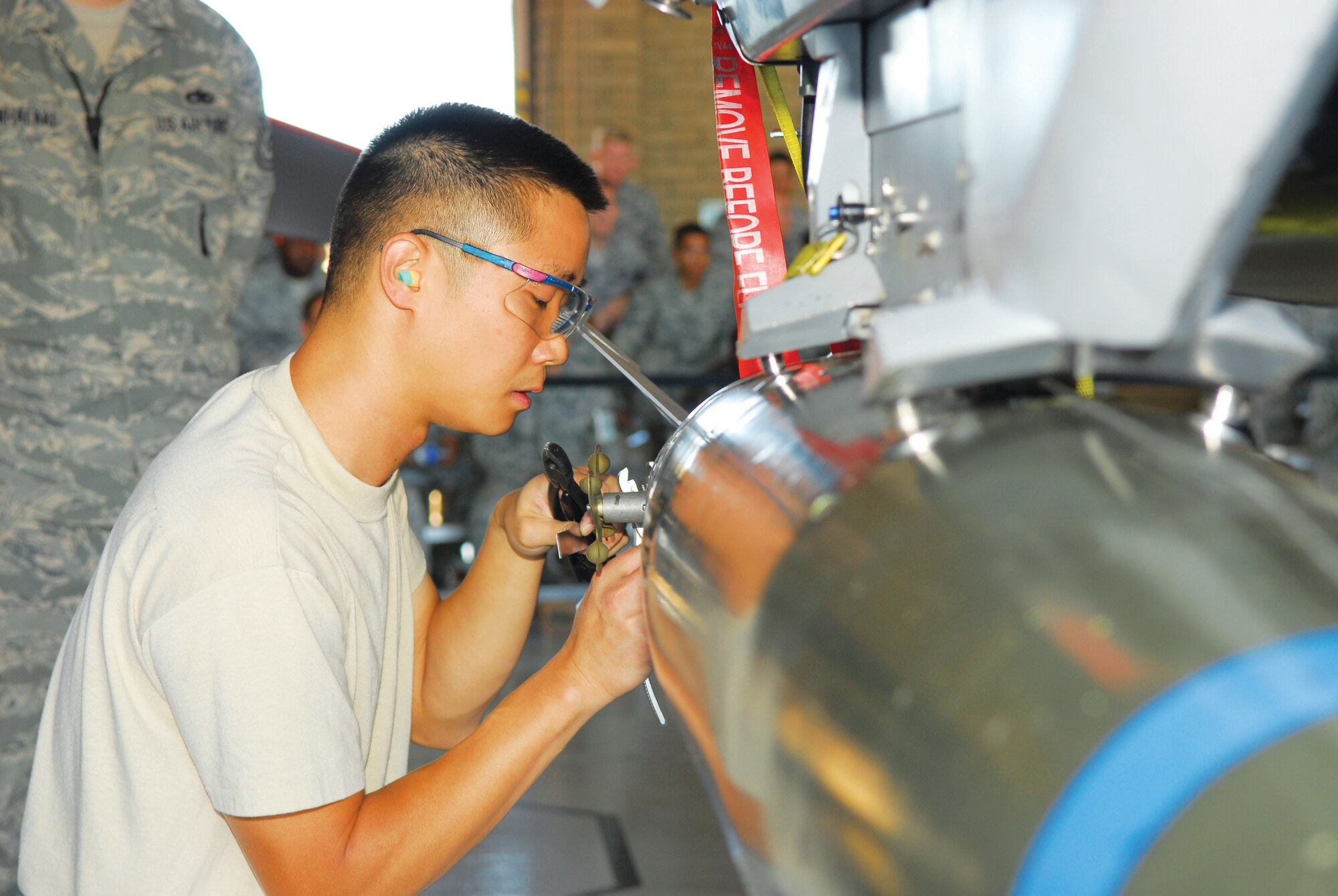 Staff Sgt. Joseph Cho, 62nd Fighter Squadron, inspects an MK-82 low drag bomb on October 8th during the Load Crew Competition in Hangar 485, Luke Air Force Base, Arizona.  The quarterly competition pits load crews from the five aircraft maintenance units against each other in a side-by-side weapons loading competition evaluated by weapons standardization personnel.  (U.S. Air Force photo/Staff Sgt. Louis Vega)
