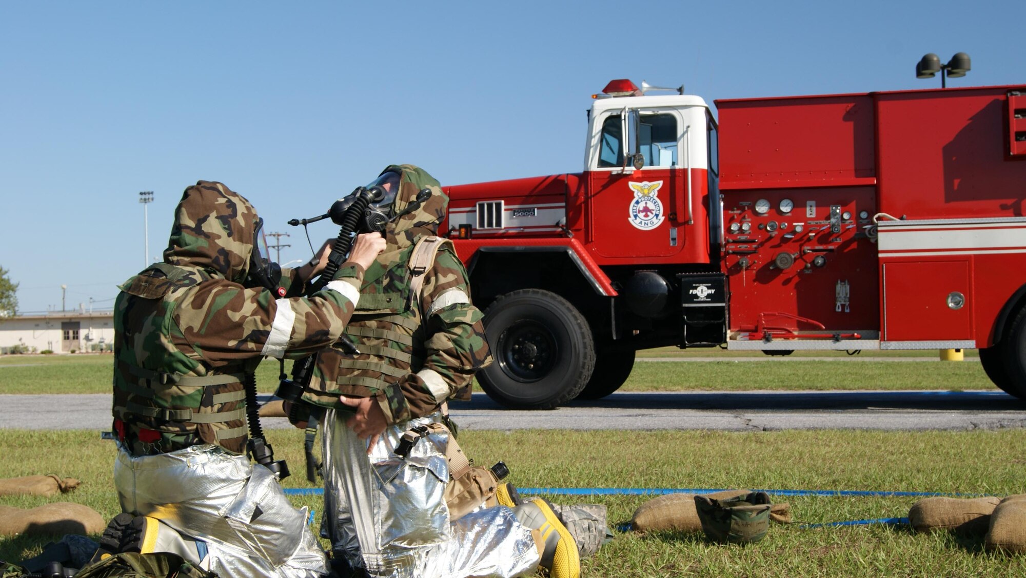 916th Air Refueling Wing firefighters work to put on their mission oriented protective posture gear in under two minutes during a recent exercise in Savannah, Ga. (USAF by MSgt. Wendy Lopedote, 916ARW/PA)