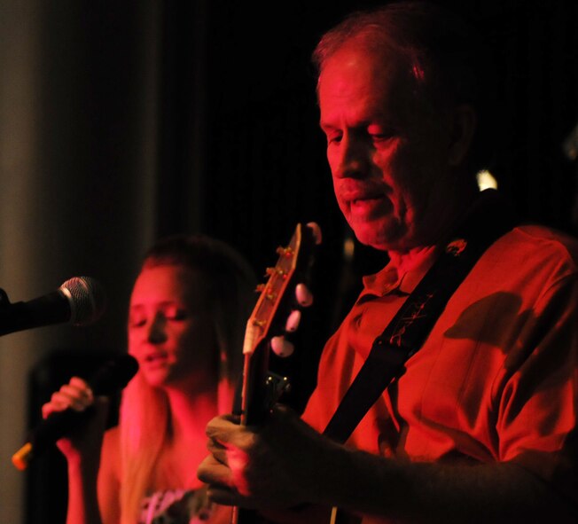 Morgan Royer, 39th Force Support Squadron, performs her first song of the night while John Drake, Incirlik Unit School teacher plays the guitar during the last night of Incirlik Idol at the Club Complex Oct. 7, 2010. Nearly 200 Incirlik members came out to watch the competition that had eight Incirlik members competing in. (U.S. Air Force photo/Senior Airman Sara Csurilla)