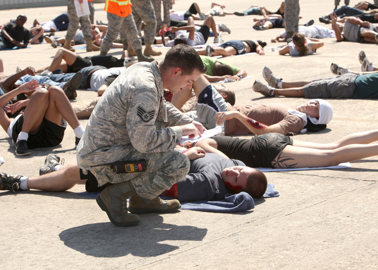 A Lackland emergency responder assesses injuries of a simulated victim during the major accident response exercise Oct. 12. Lackland conducted the MARE to prepare for the upcoming AirFest 2010, scheduled for Nov. 6 and 7. (U.S. Air Force photo/Robbin Cresswell)