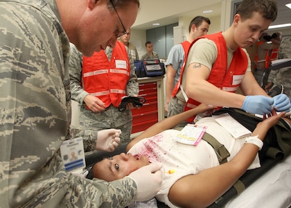 Lt. Col. James Chambers, 59th Medical Wing, treats a simulated patient during a major accident response exercise Oct. 12. Lackland conducted the MARE to prepare for the upcoming AirFest 2010, scheduled for Nov. 6 and 7. (U.S. Air Force photo/Robbin Cresswell)
