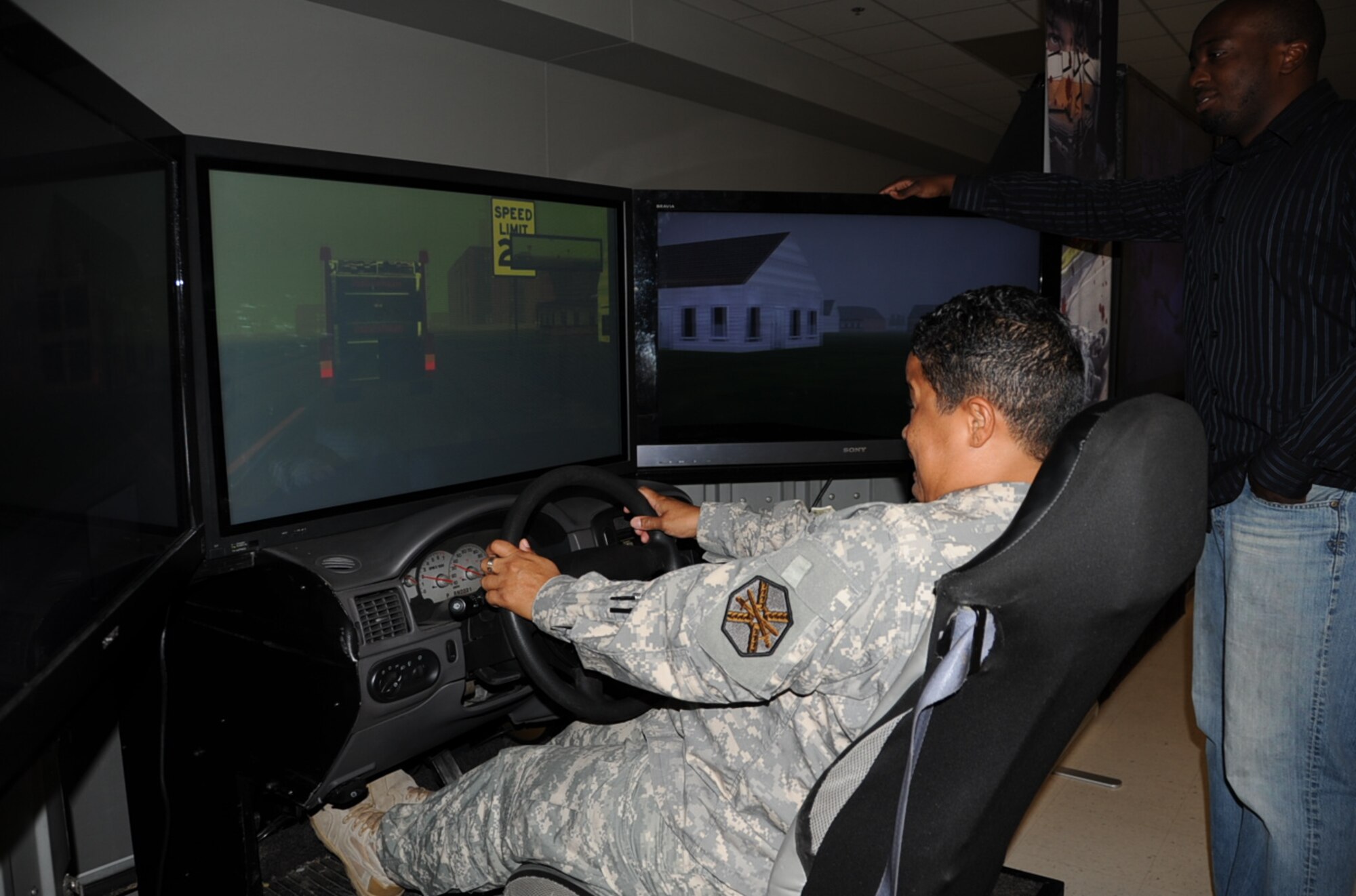 Sidney Walker, Save a Life technician, watches as Master Sgt. Lisa Youngsang, Mobilization Readiness Battalion operations NCO in charge, braces for impact as she rides the brakes on the Save a Life simulator at the Timmermann Center Wednesday. (U.S. Air Force photo/Pascual Flores) 