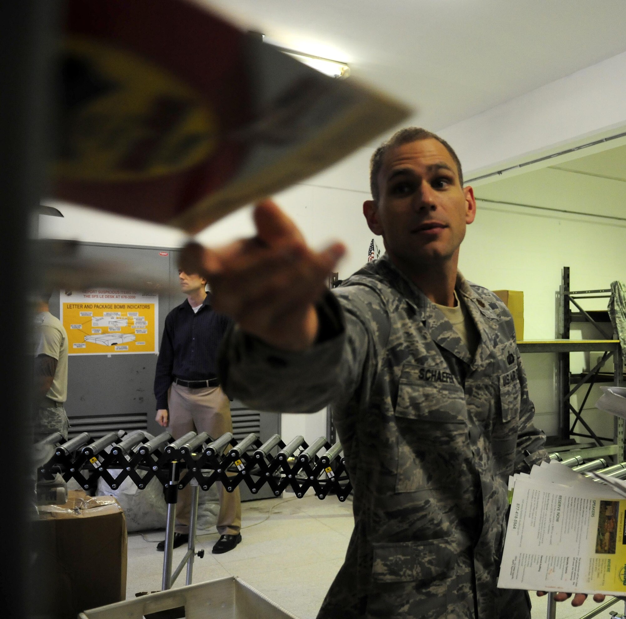 Maj. Joseph Schaefer, 39th Comptroller Squadron commander, helps separate mail Oct. 13, 2010 at Incirlik Air Base, Turkey.  The ODC processes approximately 900 packages each week and is often supported by volunteer assistance.  (U.S. Air Force photo by Senior Airman Ashley Wood/Released)