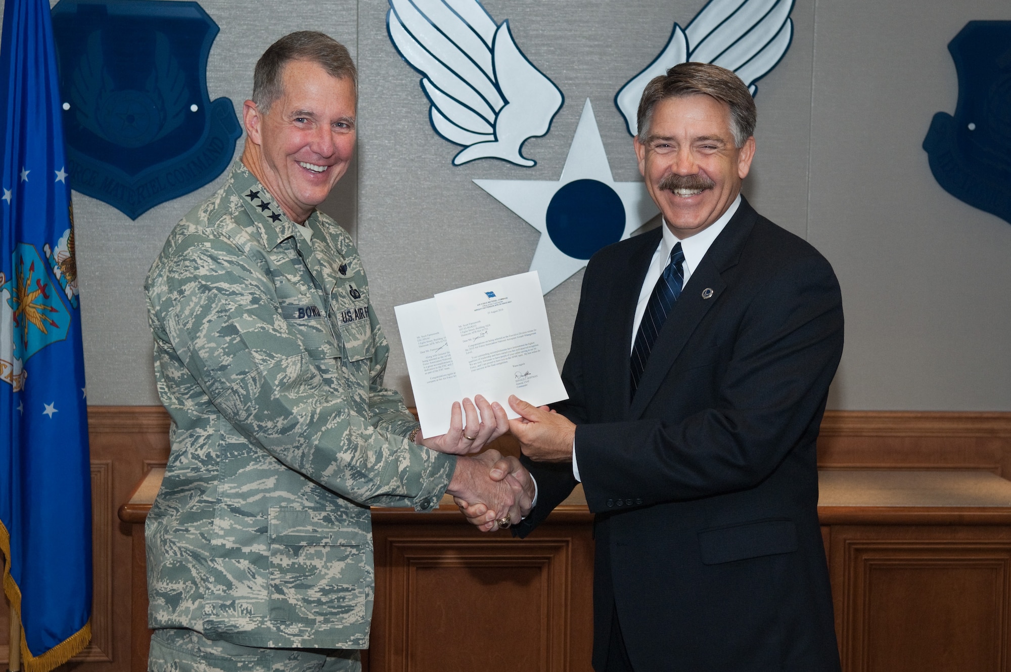 Lt. Gen. Ted Bowlds, Electronic Systems Center commander, presents Scott Farnsworth, director of the Family of Gateways Division within the Cyber and Net-centric Directorate, with a letter of congratulations for receiving an Air force Association Award for leading several critical efforts. The award was presented to Mr. Farnsworth at the AFA’s National Symposium in Washington D.C., in September.  (U.S. Air Force Photo by Rick Berry)