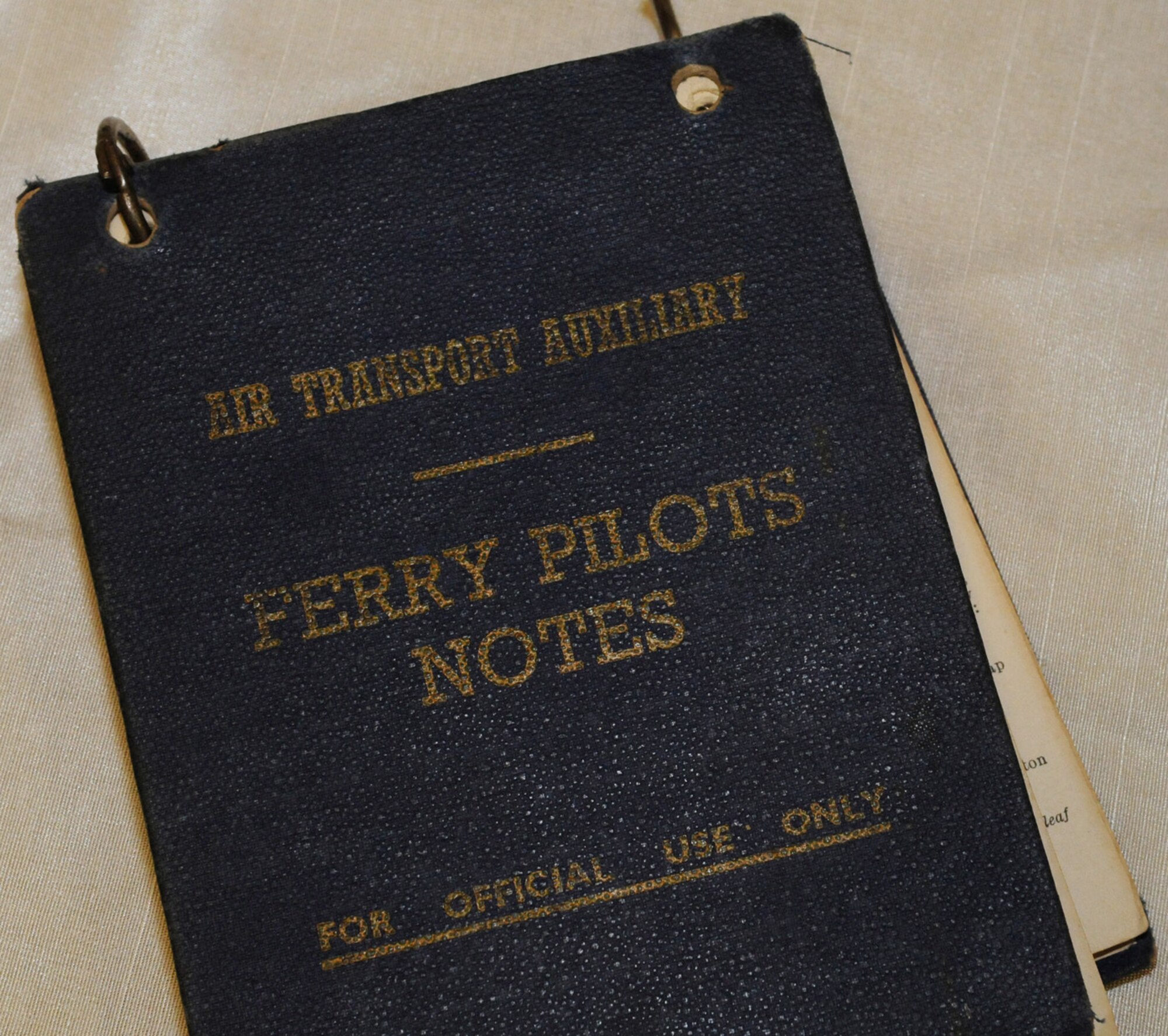 RAF MILDENHALL, England -- Thos copy of "Ferry Pilots Notes" belongs to the Eleanor Wadsworth, a former Air Transport Auxilliary 3rd officer and pilot, which she brought to show at an event 13 at Building 809. Richard Poad, chairman of the Maidenhead Heritage Centre, read out passages from the notebook, including the one-page basic instructions on "How to Fly a Spitfire." The Maidenhead Heritage Centre, near White Waltham, has the world's only dedicated Air Transport Auxiliary Exhibition and Study Centre, which is set to open in 2011. Visitors can learn how civilian pilots -- both male and female -- including 203 from the United States, contributed to victory in World War II by ferrying 309,000 war planes, of 140 different types, between factories, maintenance airfields and front-line squadrons, often with little or no training on the aircraft in question. For more information, visit www.atamuseum.org. (U.S. Air Force photo/Karen Abeyasekere)