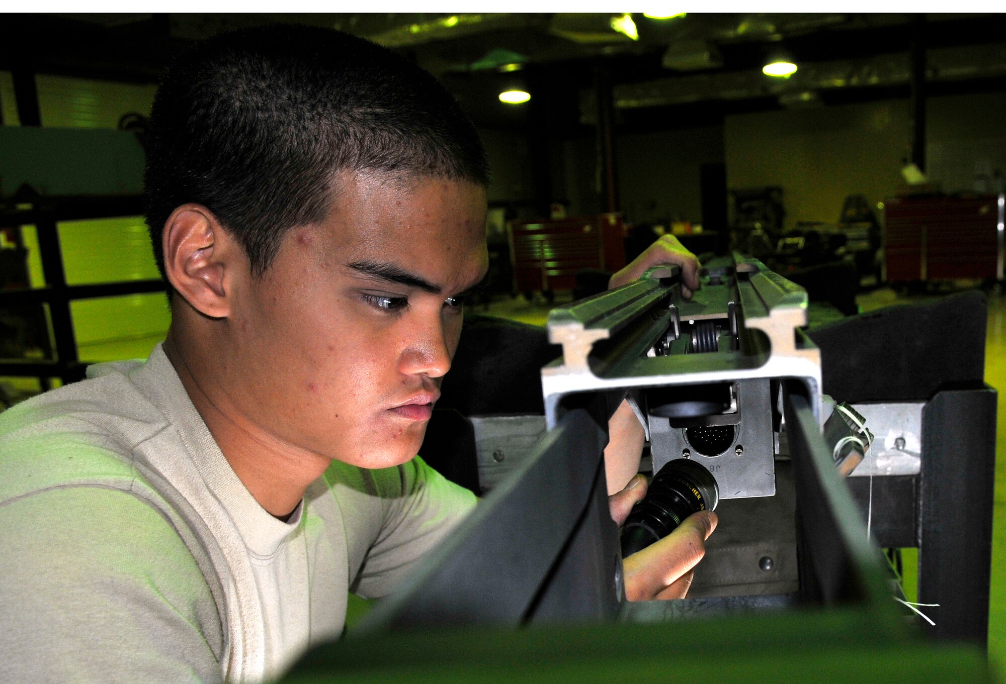 Airman 1st Class Paul Manabat, 332nd Expeditionary Maintenance Squadron aircraft armament technician, connects a stores system tester to a rebuilt launch adaptor unit to perform an electrical check. The LAU is the interfaces with a missile by holding it on the aircraft and releasing it when commanded. Airman Manabat is a native of Ketchikan, Alaska, deployed from Misawa Air Base, Japan. (U.S. Air Force photo/Tech. Sgt. Phillip Butterfield)