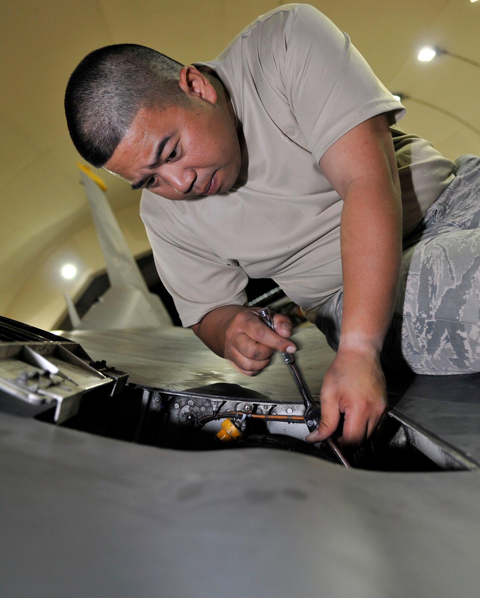 Staff Sgt. Sherwyn Mabute, 332nd Expeditionary Maintenance Squadron aircraft armament technician, tightens a mounting bolt on a M-61A1 20mm multi-barrel cannon oiling unit after replacing a malfunctioning unit on the F-16 Fighting Falcon Oct. 10, 2010, Joint Base Balad, Iraq. The M61A1 is a six-barreled automatic rotary weapon that can fire at a rate of 6,000 rounds per minute. Sergeant Mabute is a native of Kodiak, Alaska, deployed from Misawa Air Base, Japan. (U.S. Air Force photo/Tech. Sgt. Phillip Butterfield)
